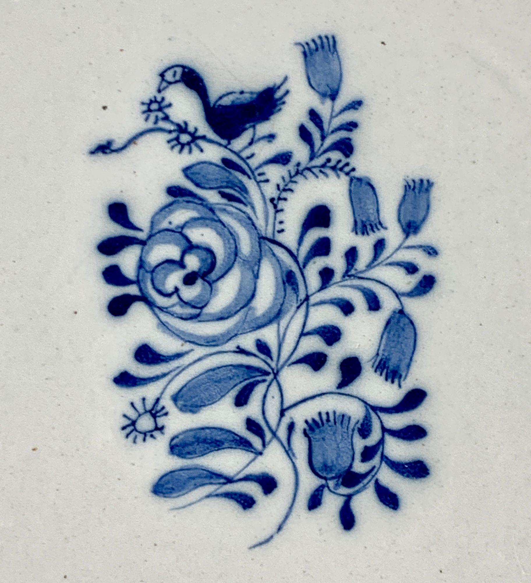 This charming pair of hand-painted blue and white Dutch Delft bowls is decorated in two tones of cobalt blue.
The decoration is delicate, elegant, and informal.
At the center, we see a bird atop flowers, some in full bloom, others budding or