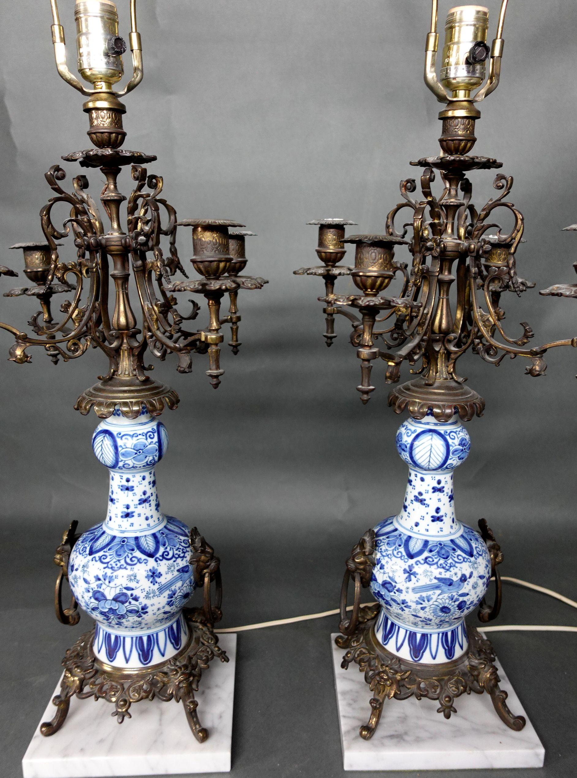 Pair of Blue and White Porcelain vases/lamp bases
mounted on metal feet and stand on a square marble base, electrified, overall ht. 31 1/2, vase ht. 10 in.
The lamps are working well.


