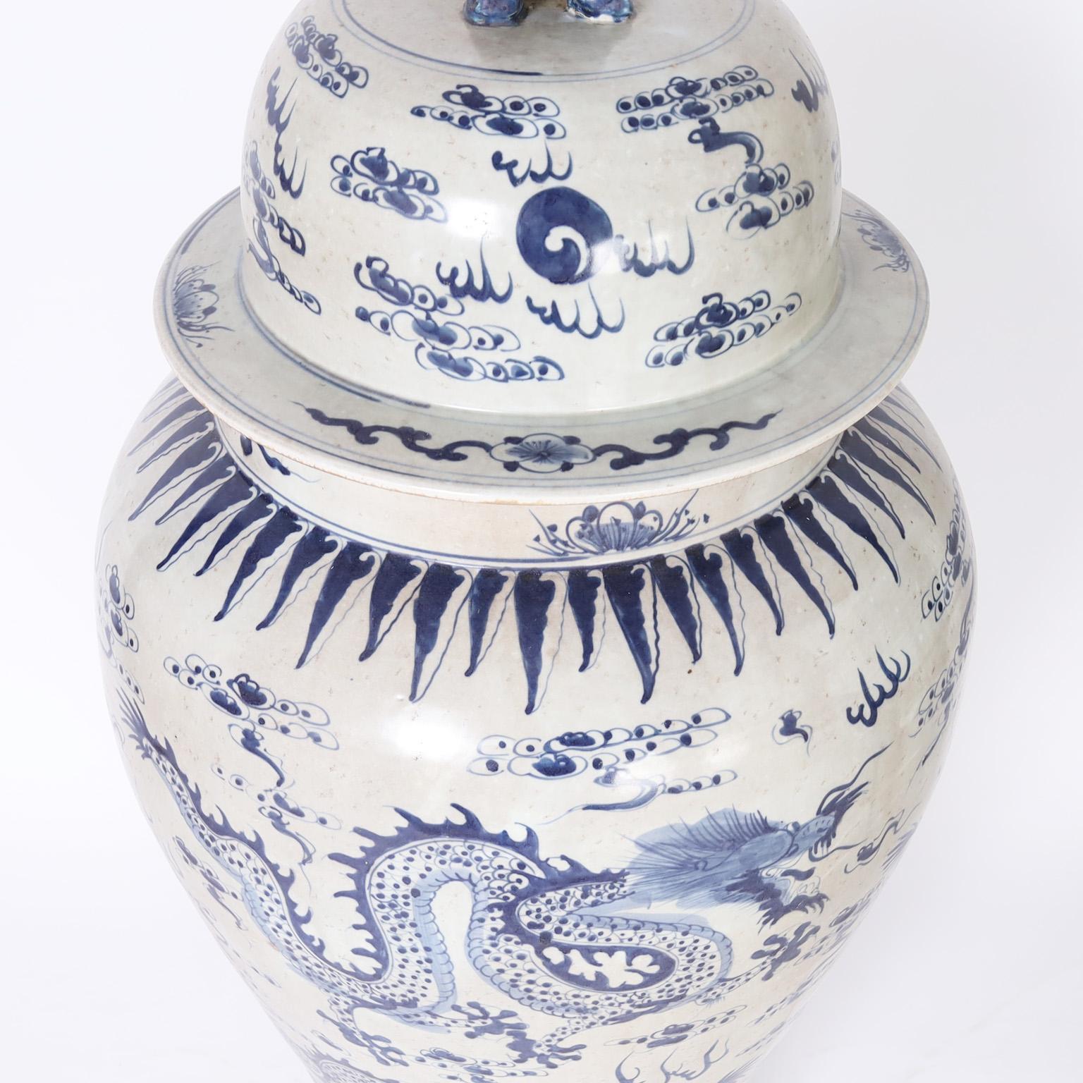 Porcelain Pair of Blue and White Lidded Palace Urns with Dragons