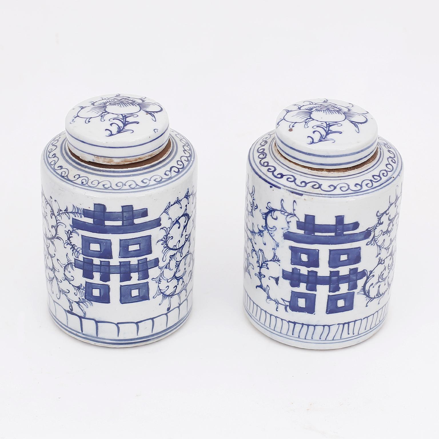 Pair of Chinese blue and white porcelain lidded ginger jars hand decorated with double happiness characters and delicate floral designs, in the Chinese Export manner.