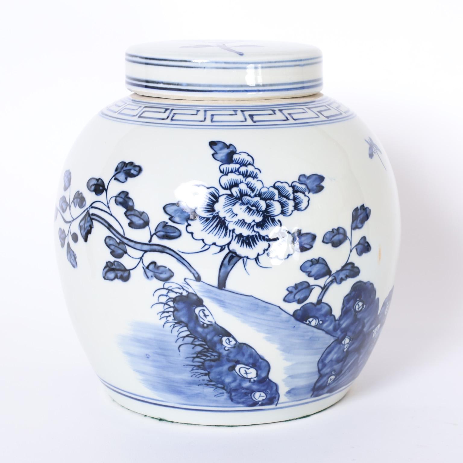 Glazed Pair of Blue and White Porcelain Lidded Jars with Flowers