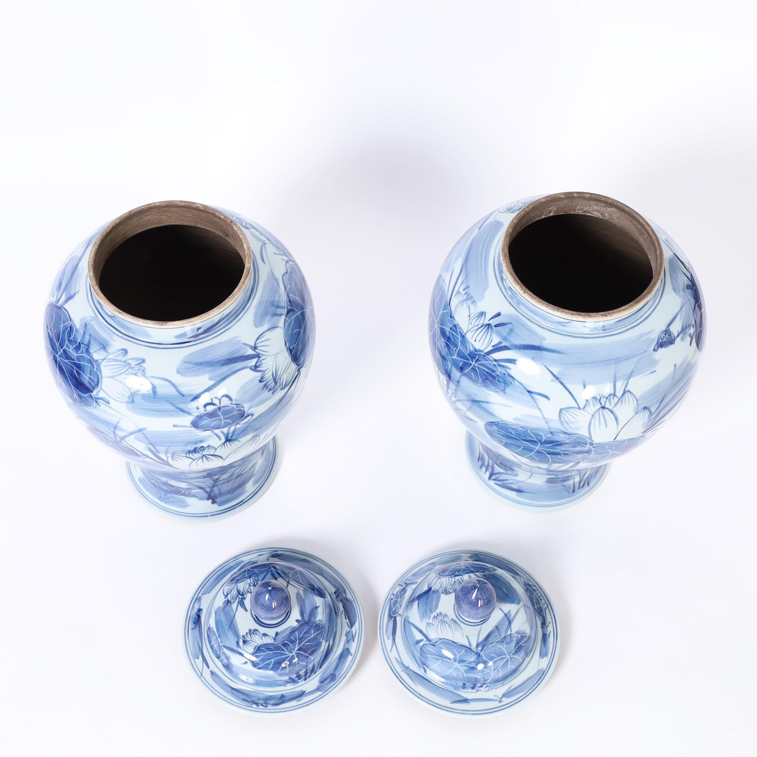 Chinese Pair of Blue and White Porcelain Lidded Urns with Lilies For Sale