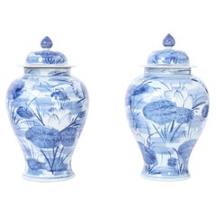 Vintage Pair of Blue and White Porcelain Lidded Urns with Lilies