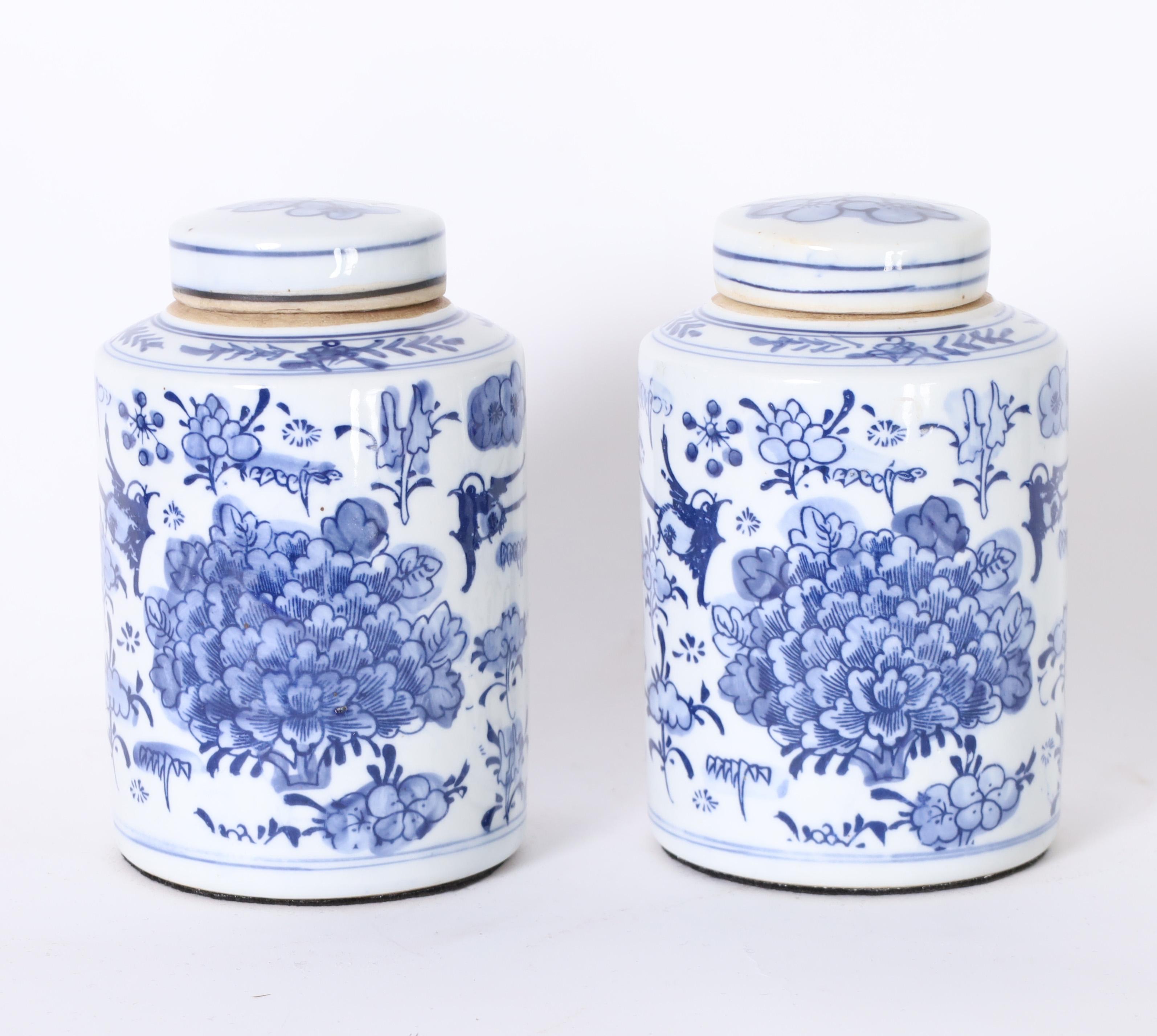 Delightful pair of Chinese blue and white porcelain lidded ginger jars hand decorated with lotus leaves and flowers. 