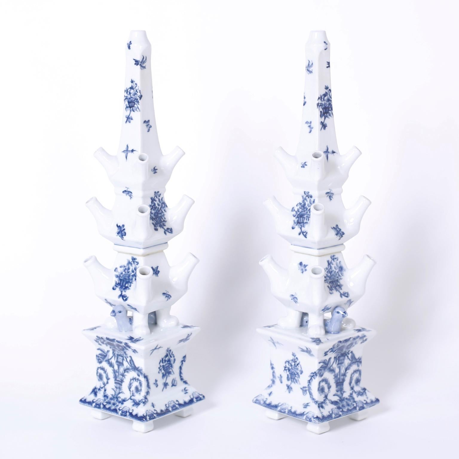 Pair of blue and white tulipieres with a pagoda or obelisk form and featuring song birds at the front and back and hand decorated with delicate fauna and flora designs.