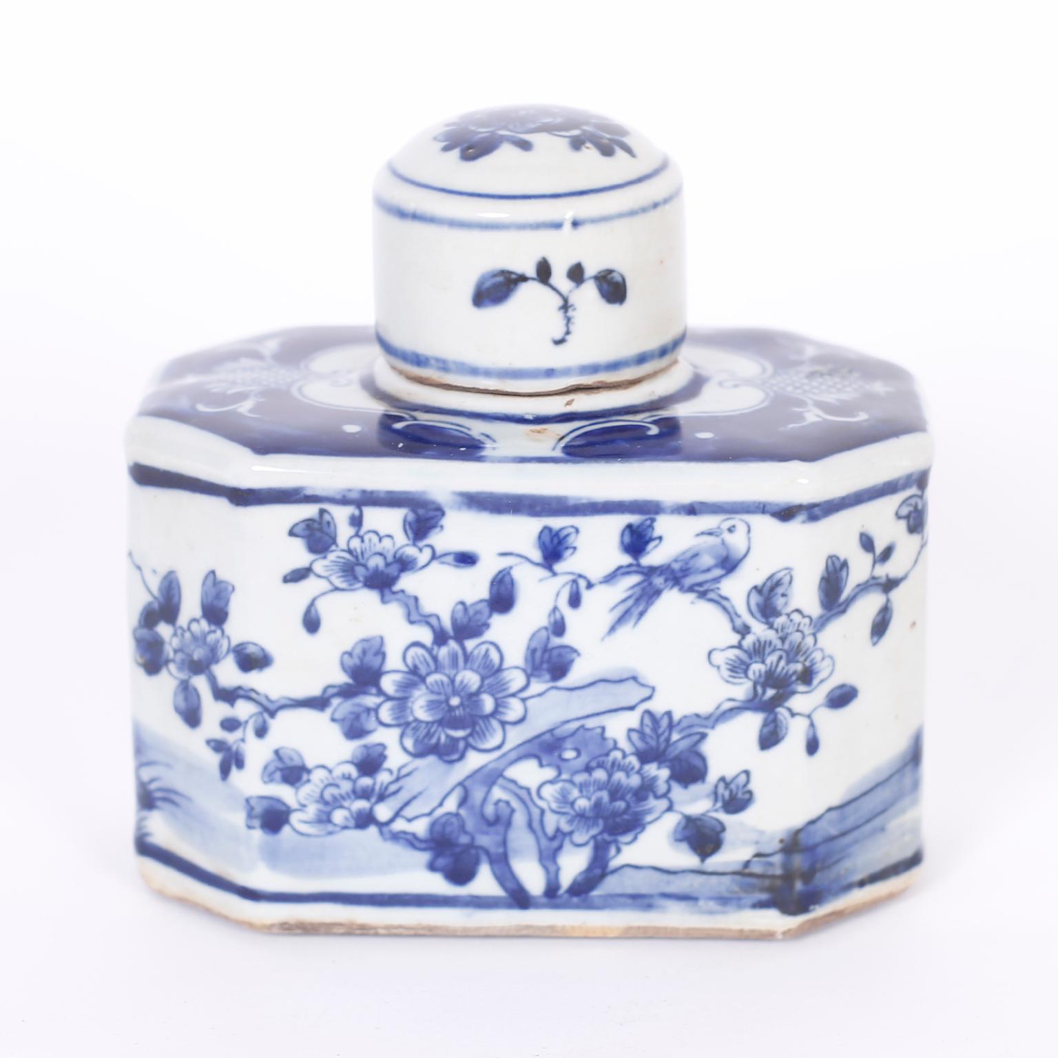 Pair of classic Chinese blue and white porcelain tea caddies with an unusual octagon form hand decorated with delicate floral designs.