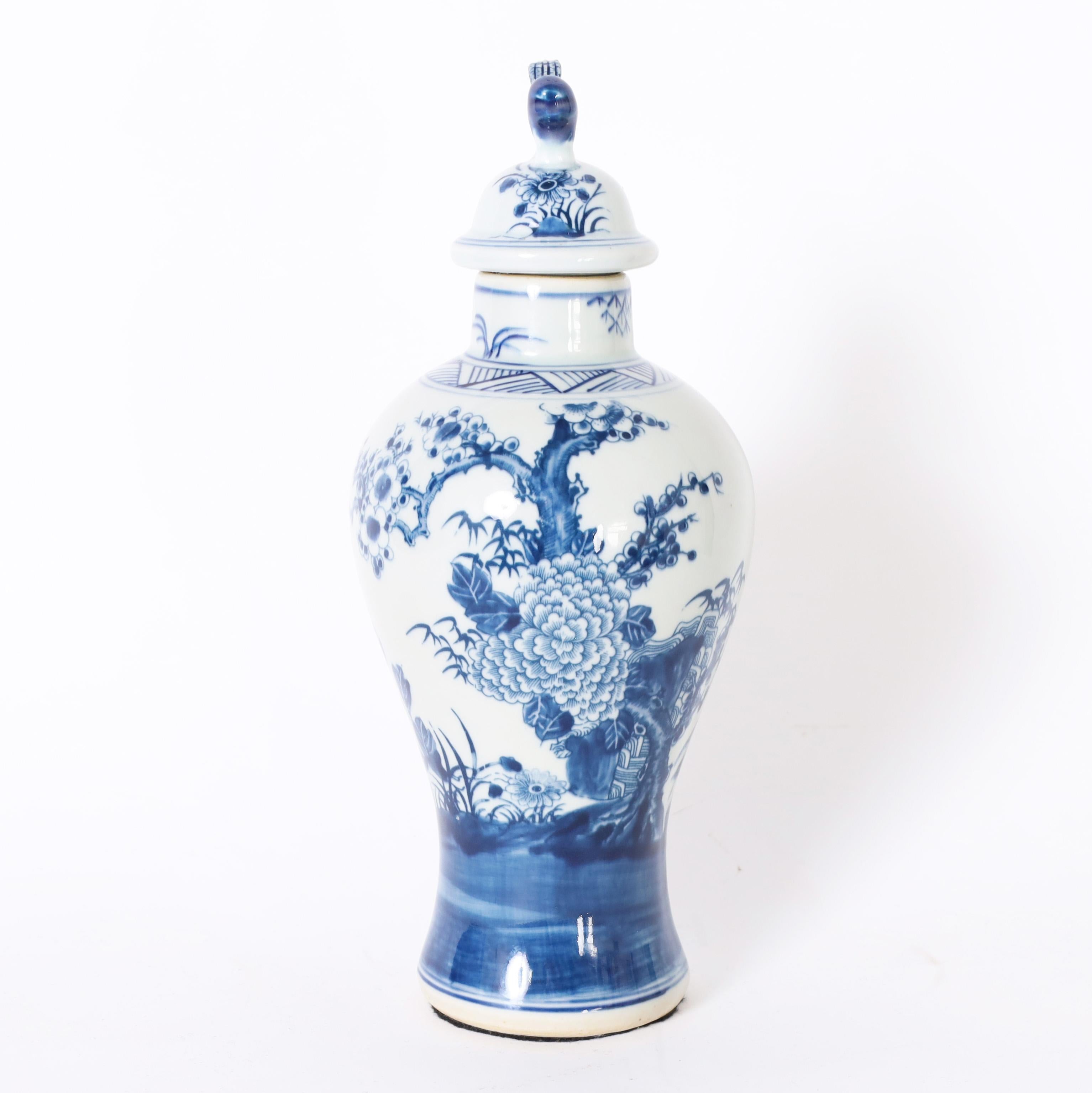 Chinese Pair of Blue and White Urns or Jars With Flowers For Sale
