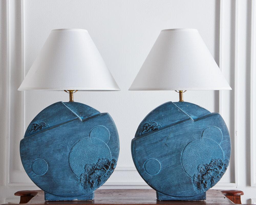 A pair plaster table lamp featuring a circular base with an abstract architectural raised design. Signed Bon Art, 1989.

 