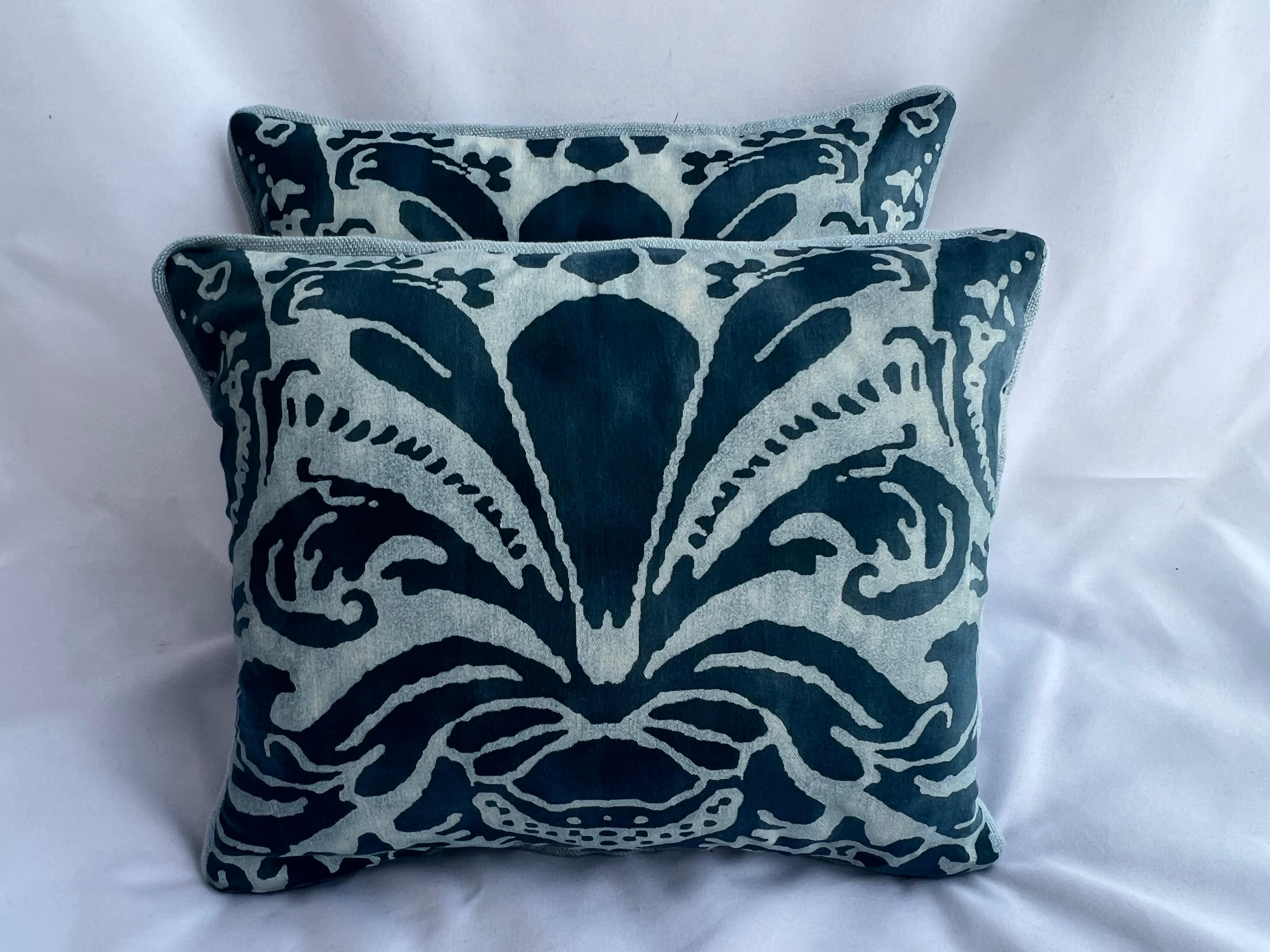 Pair of unique custom pillows made with discontinued Caravaggio patterned Fortuny pillow fronts and soft faded blue linen backs.  Self cording, down inserts, zipper closures.