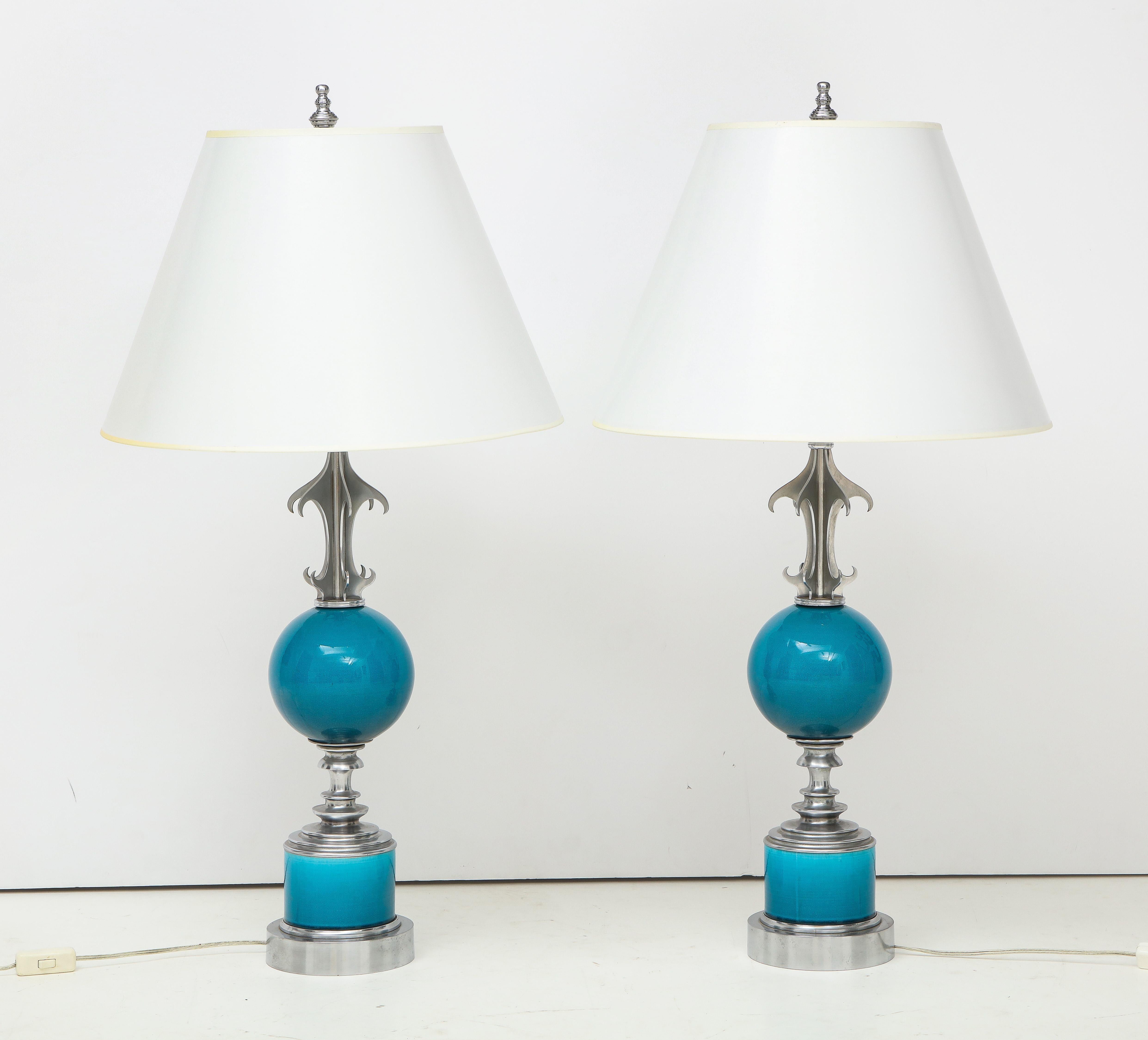 Unique nickel-plated lamps with, blue ceramic globes and detailed bases.