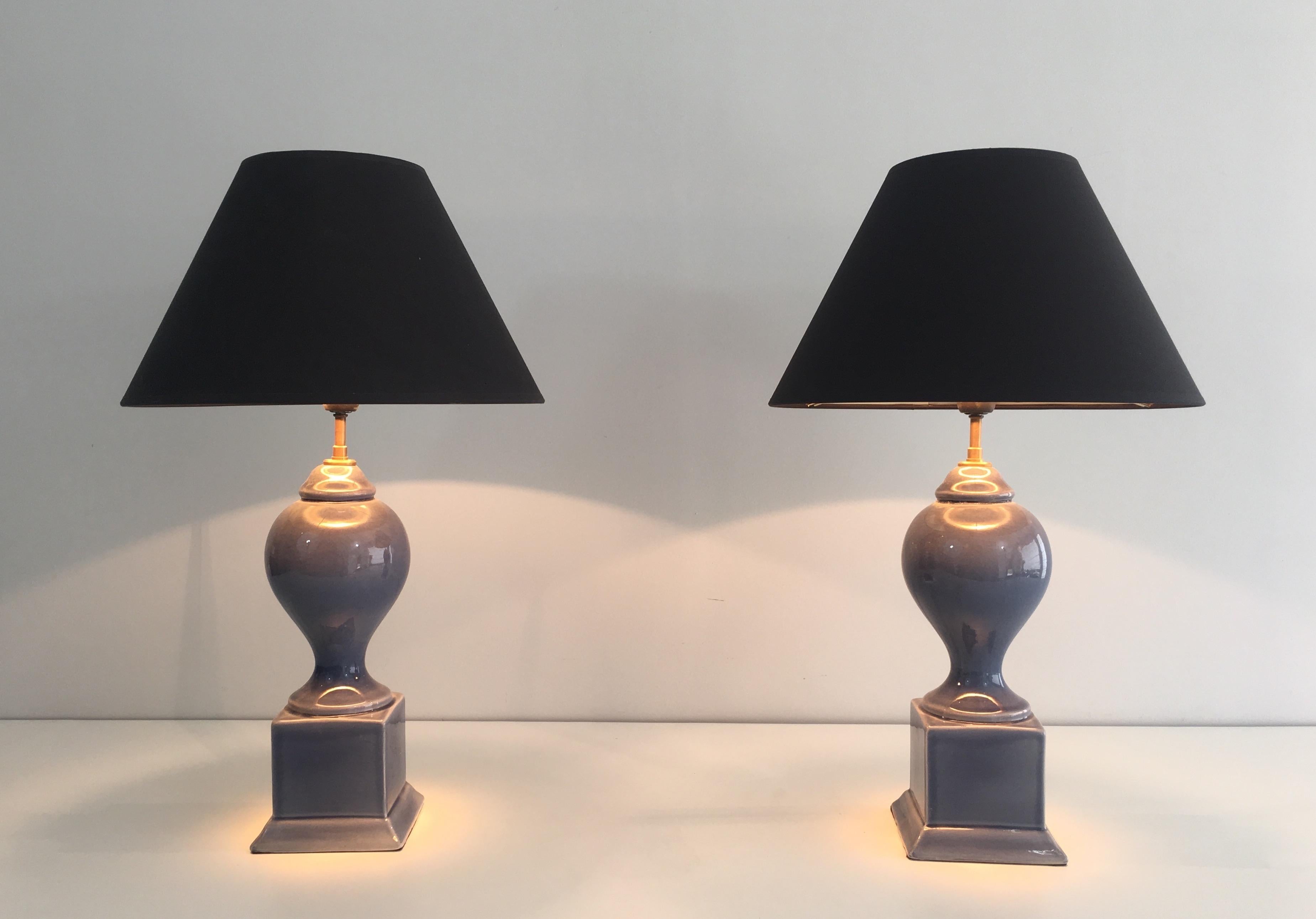 This pair of baluster table lamps is made of blue ceramic. They have new black shintz shades gilt inside. This is a French work, circa 1970.