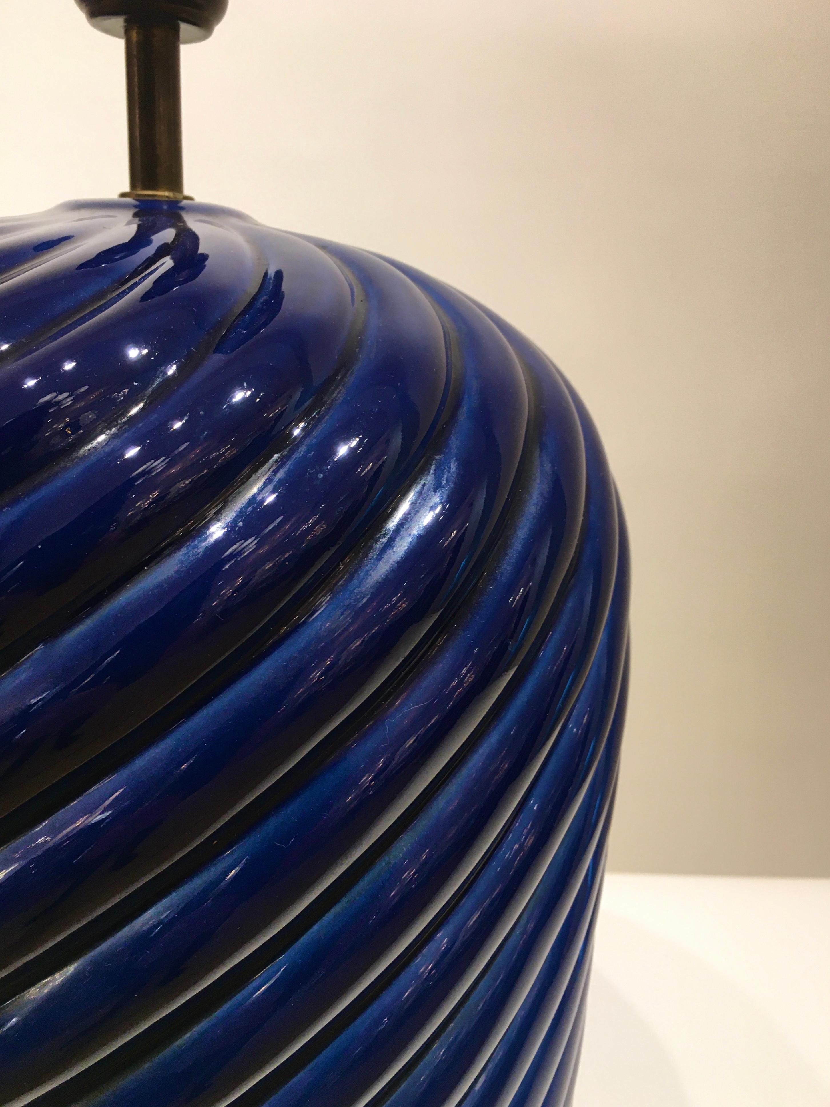 A wonderful pair of dark blue glazed ceramic table lamps designed by the Italian designer Tommaso Barbi. Manufactured by B.Ceramiche in the early 1970s, this rare blue colored example of Barbi's Classic spiral table lamp is finished at the base with