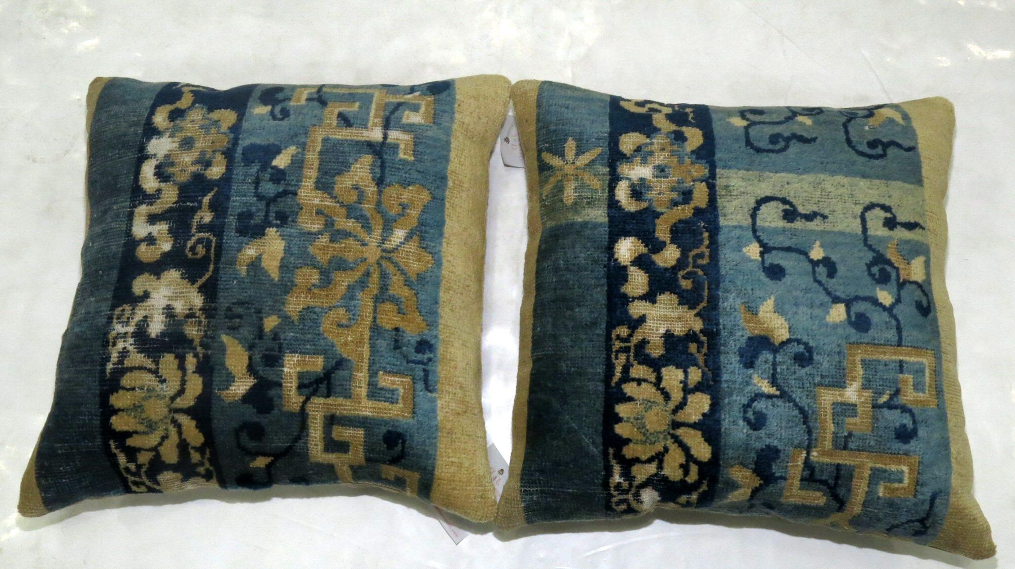 Set of 2 pillows from an early 20th century Chinese rug each measuring 17'' x 18''.