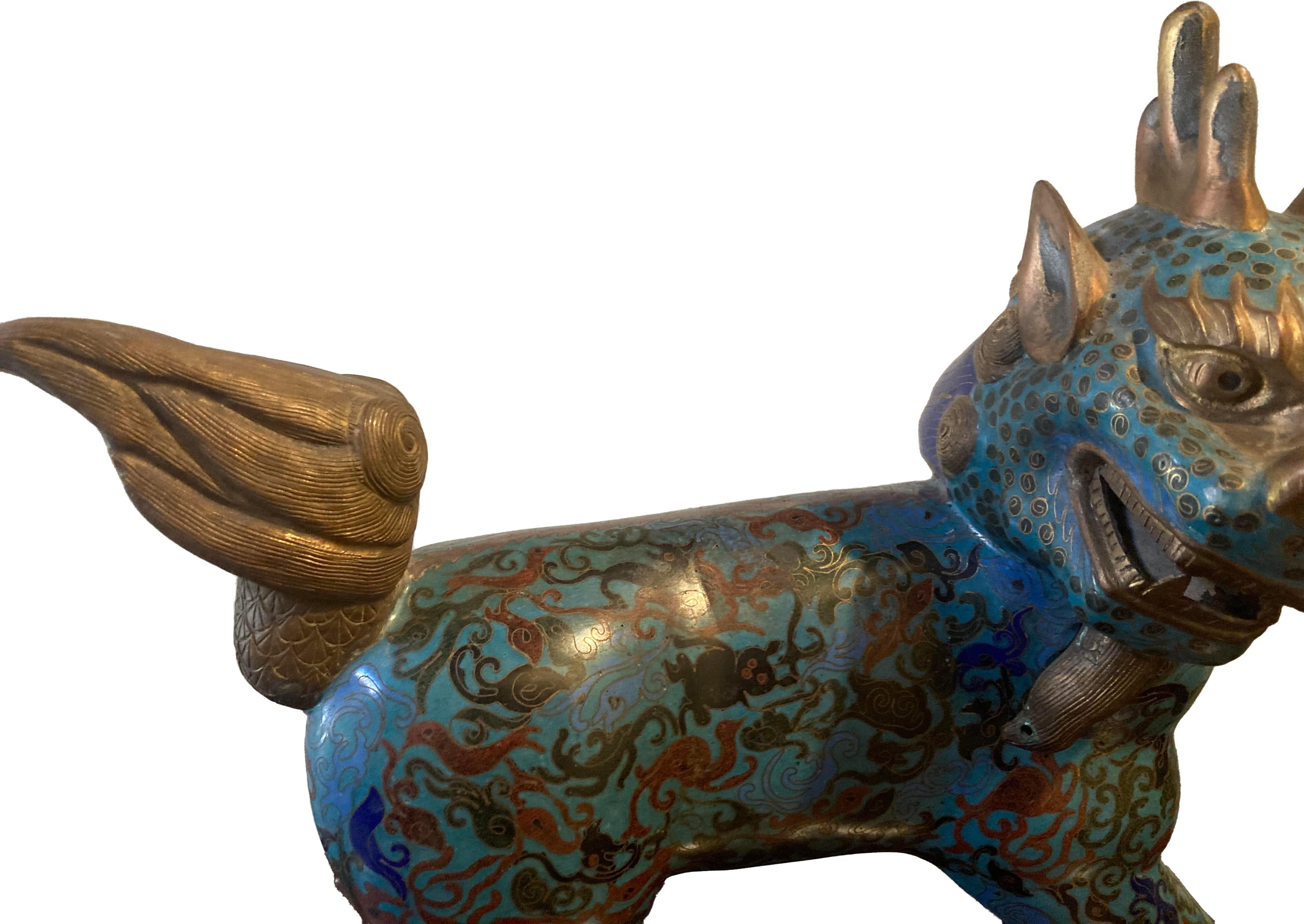 Bright blue and turquoise Cloisonne with terra cotta red detailing; in great condition. This is a very unique Fu dog representation that is highly stylized.