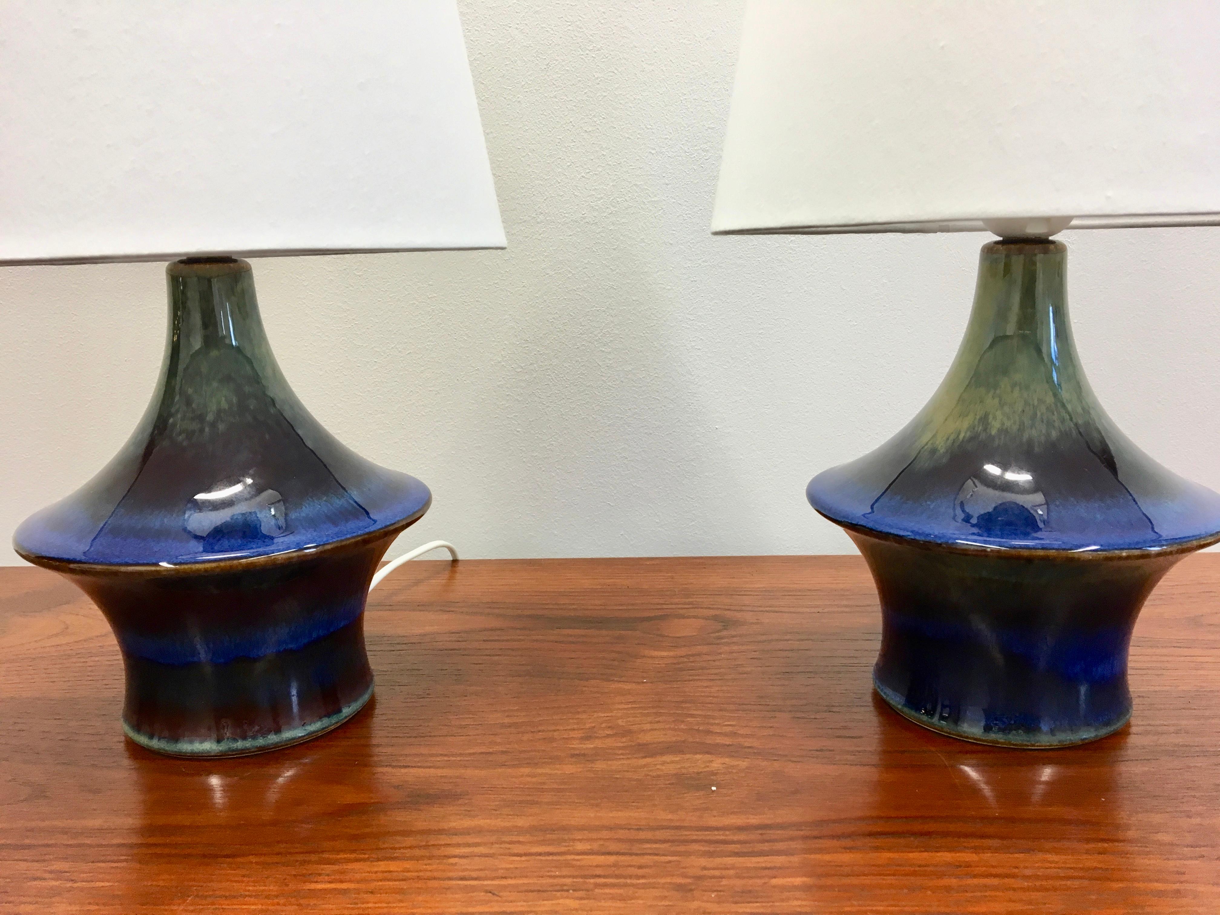 This pair of ceramic table lamps was produced by Danish company Soholm Stentoj in the 1960s.
The lamps are made of ceramic glazed stoneware. The glaze is a beautiful mixture of blue and greenish tones. The lamps have been rewired for European usage