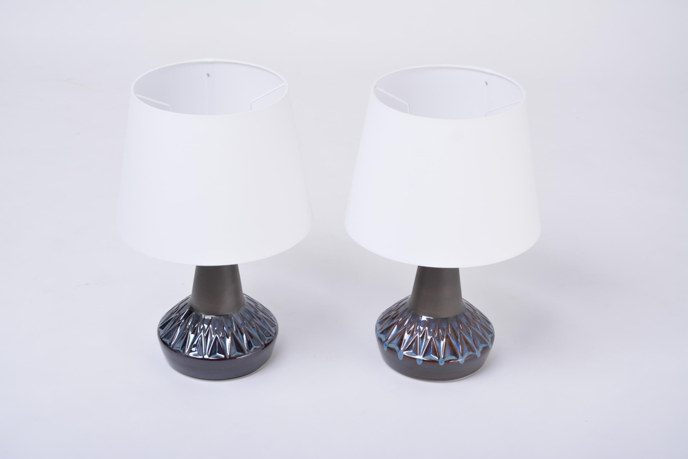 Pair of Blue Danish Mid-Century Modern table lamps by Einar Johansen for Soholm

Gorgeous pair of Danish table lamps designed by Einar Johansen and produced by Soholm Stentoj on the island of Bornholm. The lamps feature a beautiful incised