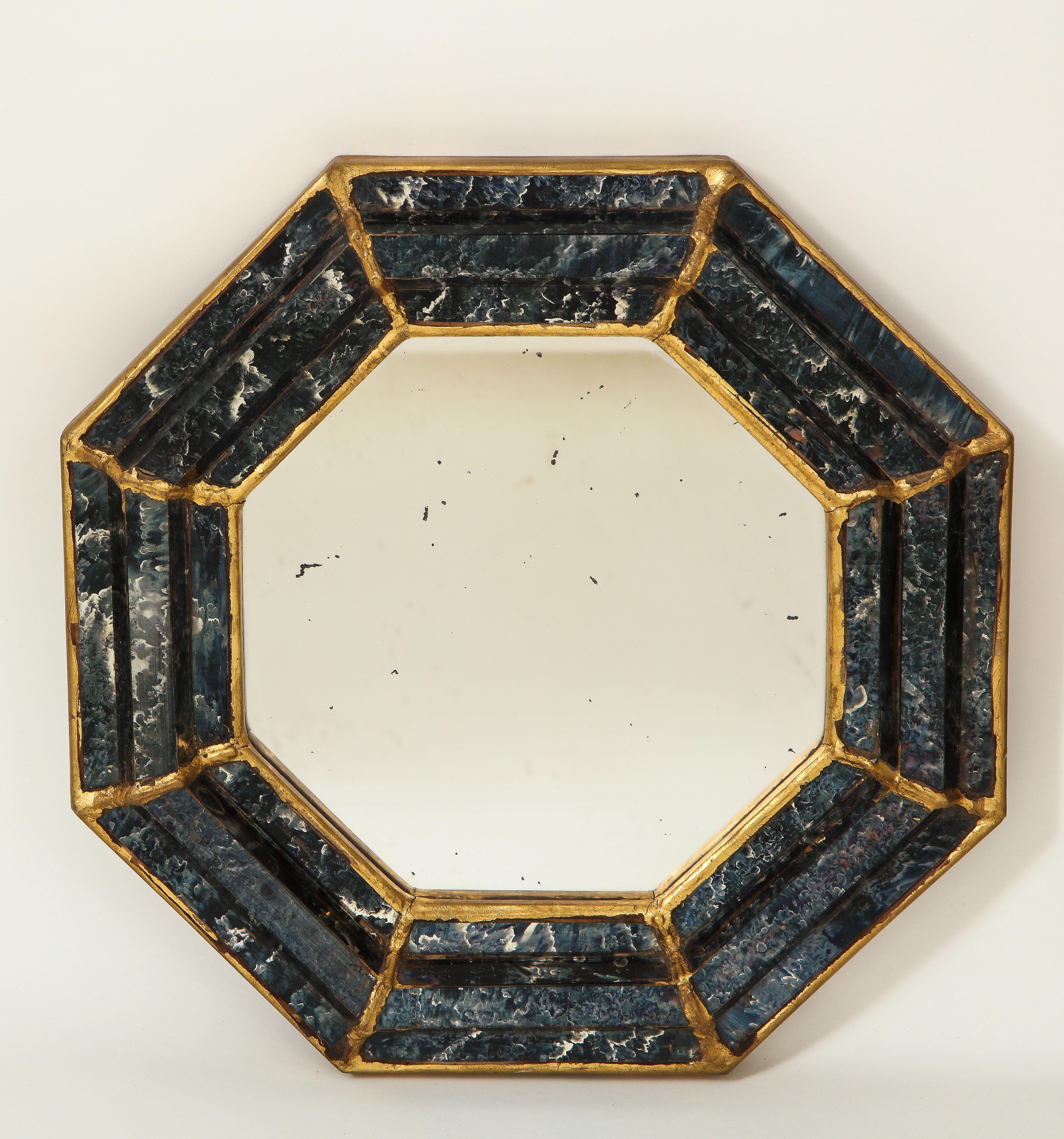 Each mirror plate within a conforming reverse painted glass border with blue faux marble decoration and gilt borders.