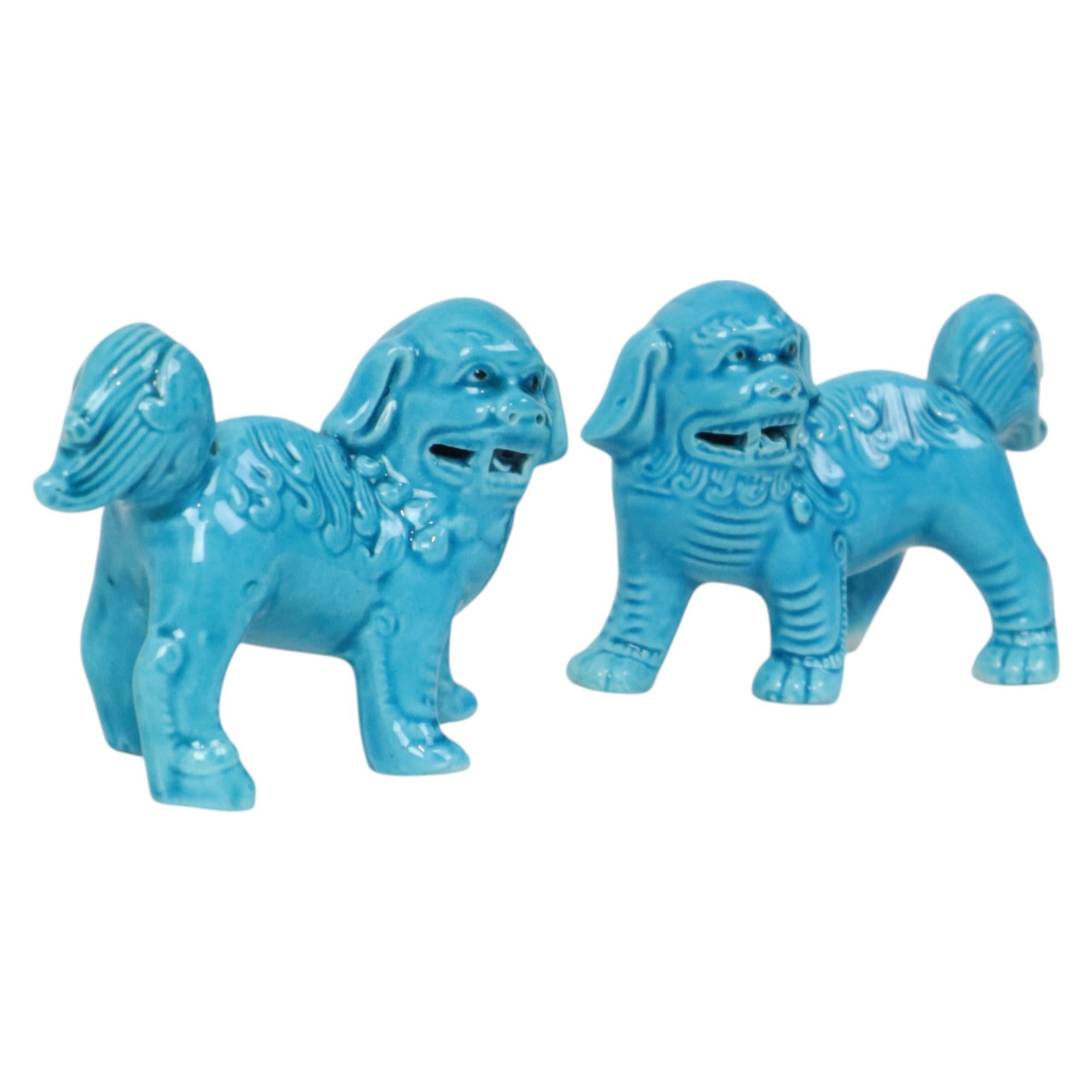 A charming pair of blue Foo Dog figurines, small temple lions, made of turquoise-glazed Chinese porcelain, late 20th century, unmarked and unnumbered.

These temple lions mirror each other and are hand-painted. They are richly detailed and