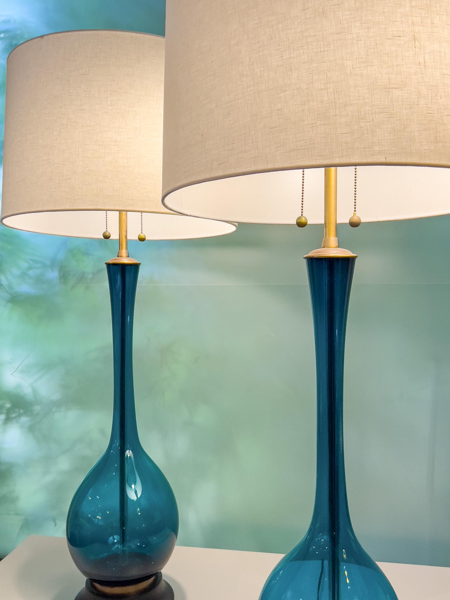 A pair of large scale blue glass lamps by Marbro. Rewired.