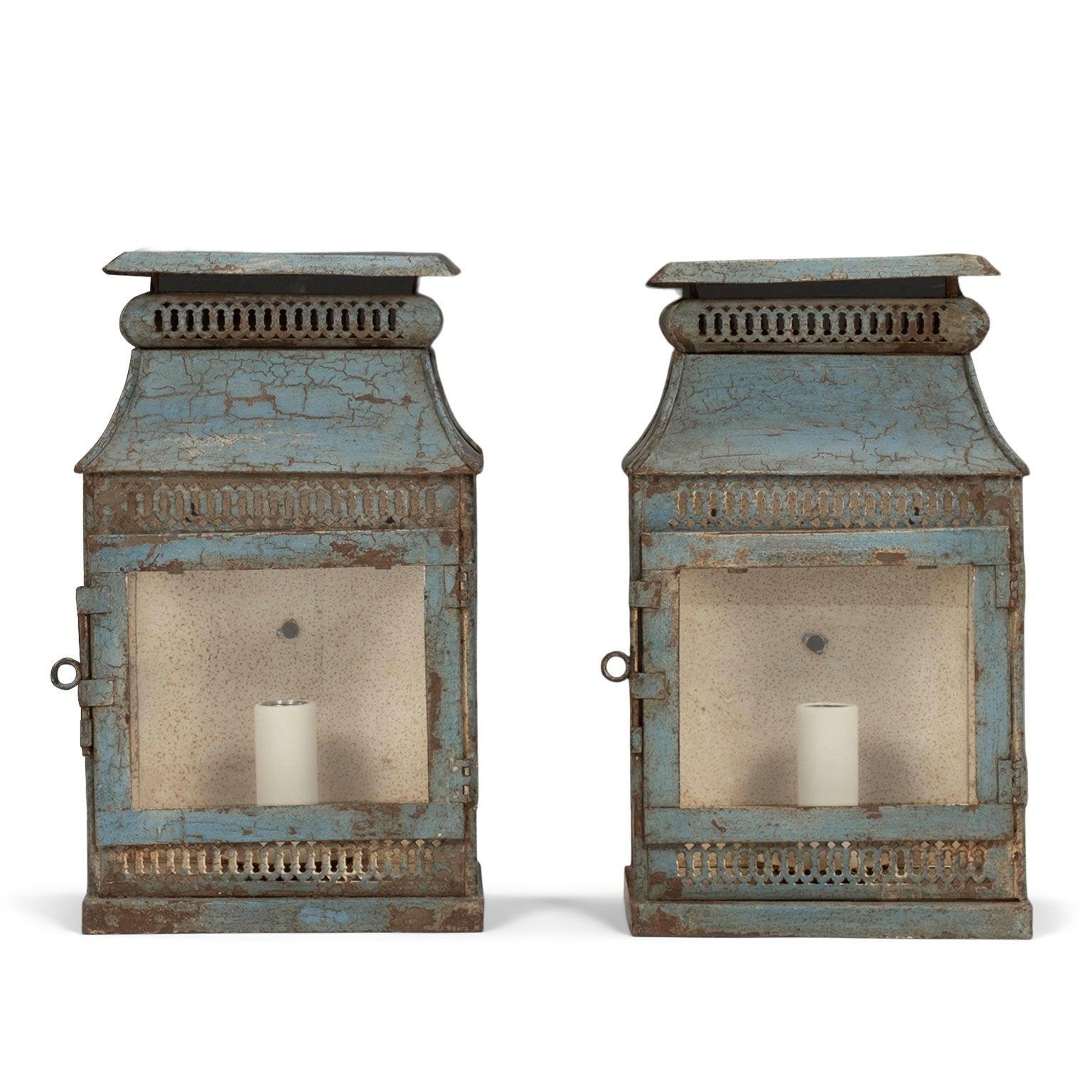 Pair of blue-painted tole wall lanterns dating to the 19th century. Pierced decoration, glass front and sides. Newly-wired for use within the USA with one medium-size socket in each lantern. Sold together and priced $5,600 for the pair.