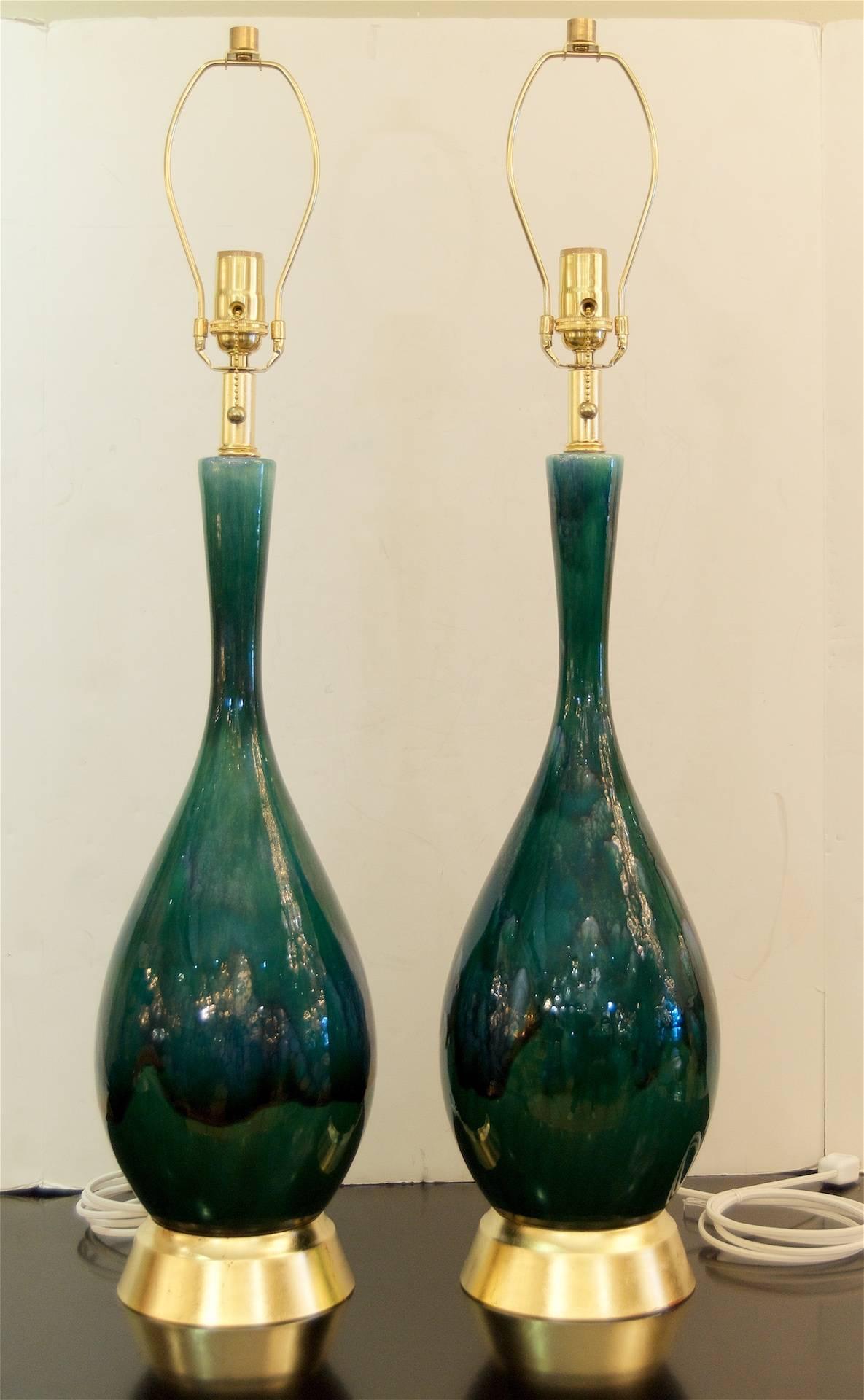 Excellent pair of midcentury drip glaze lamps in blue and green tones, with particularly excellent variegation to the glaze and pleasing craquelure, believed to be Royal Haeger. Hardware newly gilt.

New wiring. Height listed is with 8