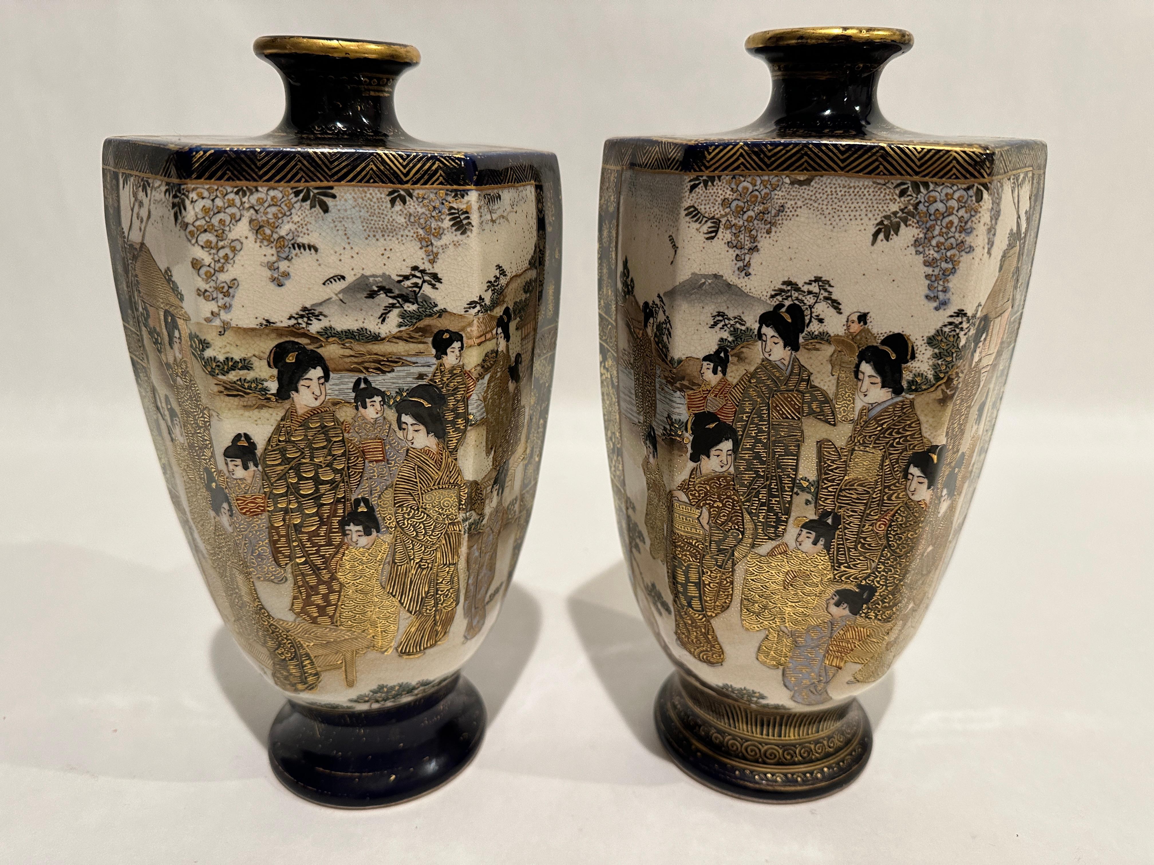 These are a very good quality pair of earthenware Japanese Satsuma vases, beautifully hand decorated and from the Meiji period, circa 1880. The vases have a hexangular shape raised on a circular foot, with a sharp shoulder and a small neck and