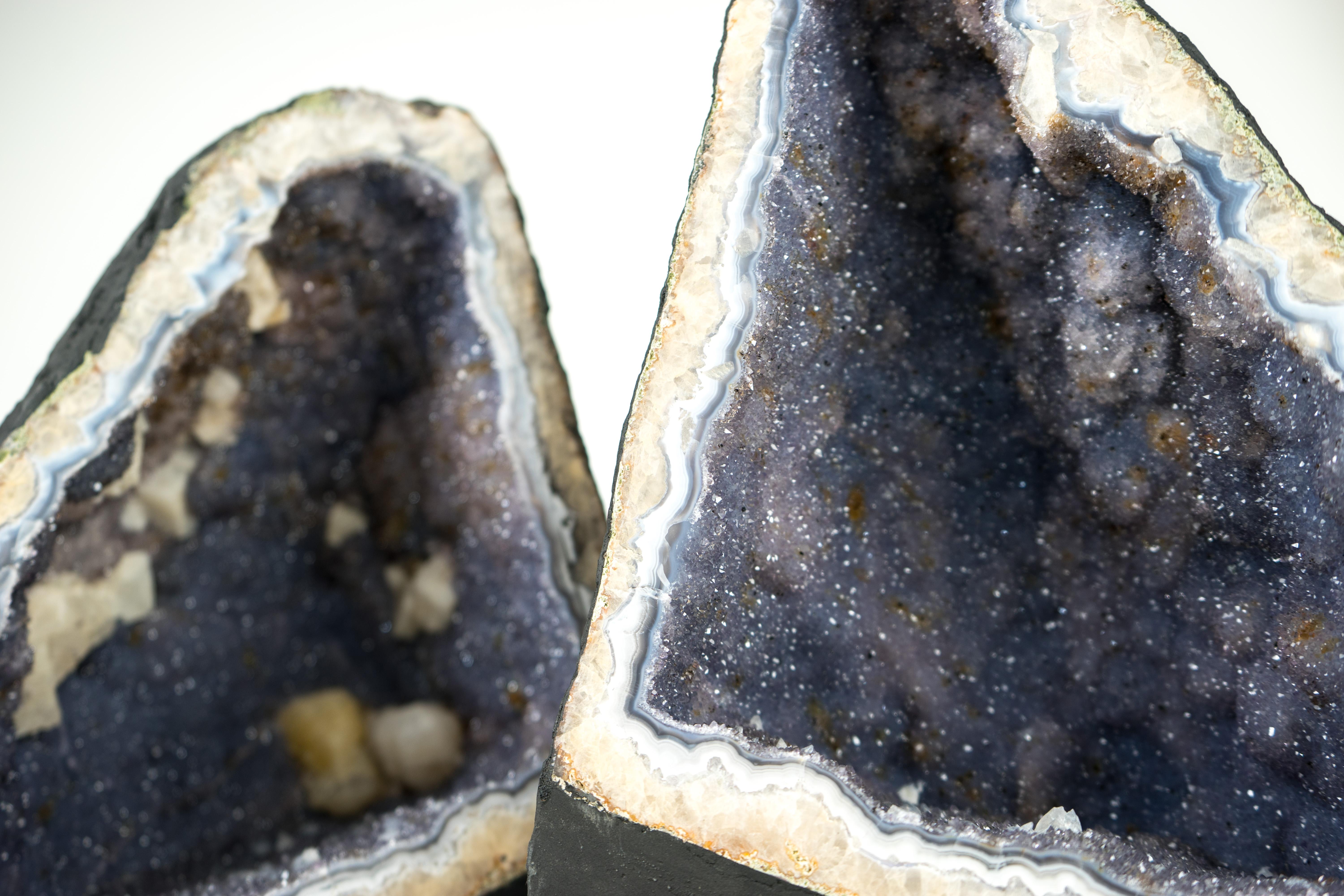 Rare Agate Amethyst Geodes, with Lavender Galaxy Amethyst Druzy and Calcite

▫️ Description

A pair of natural Agate Geodes, each with rare characteristics, form truly natural artworks. Blue and white agate bandings, lavender galaxy druzy, and the