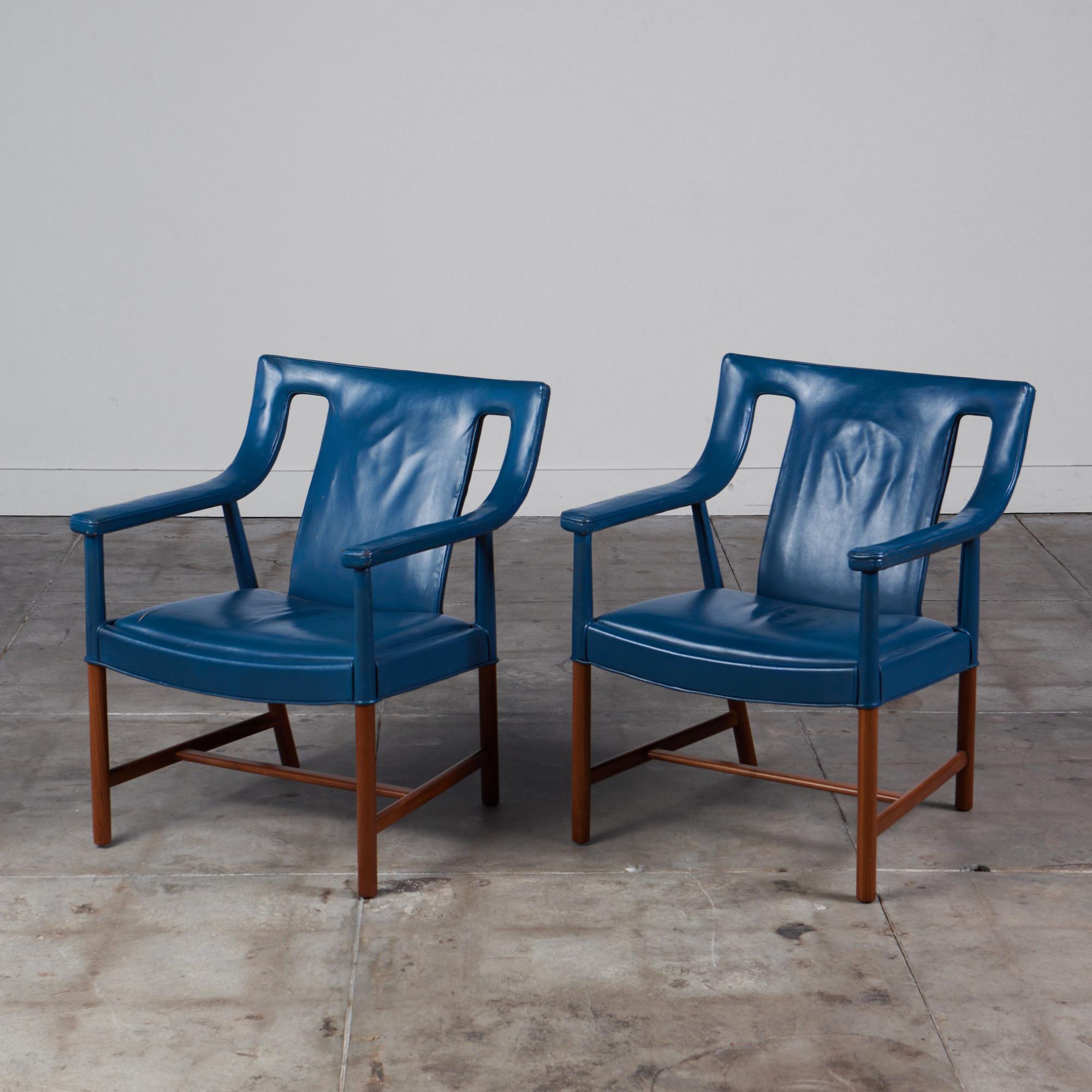 Rare pair of teak and leather chairs by Ejner Larsen and Aksel Bender Madsen, for Ludvig Pontoppidan, c.1940s. These chairs feature the original blue leather. The sculpted armrests and legs are made from teak and leather wrapped. The legs are