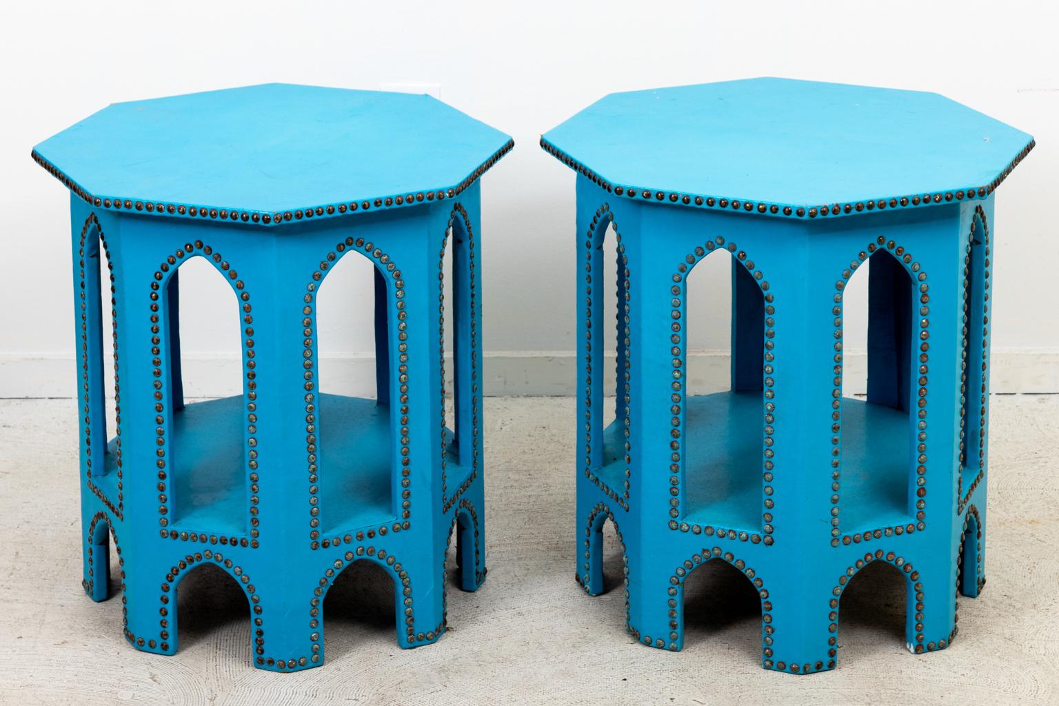 Circa late 20th century pair of blue leather Moroccan style octagonal stands with metal nail head trim and pointed arches. Please note of wear consistent with age including minor chips.