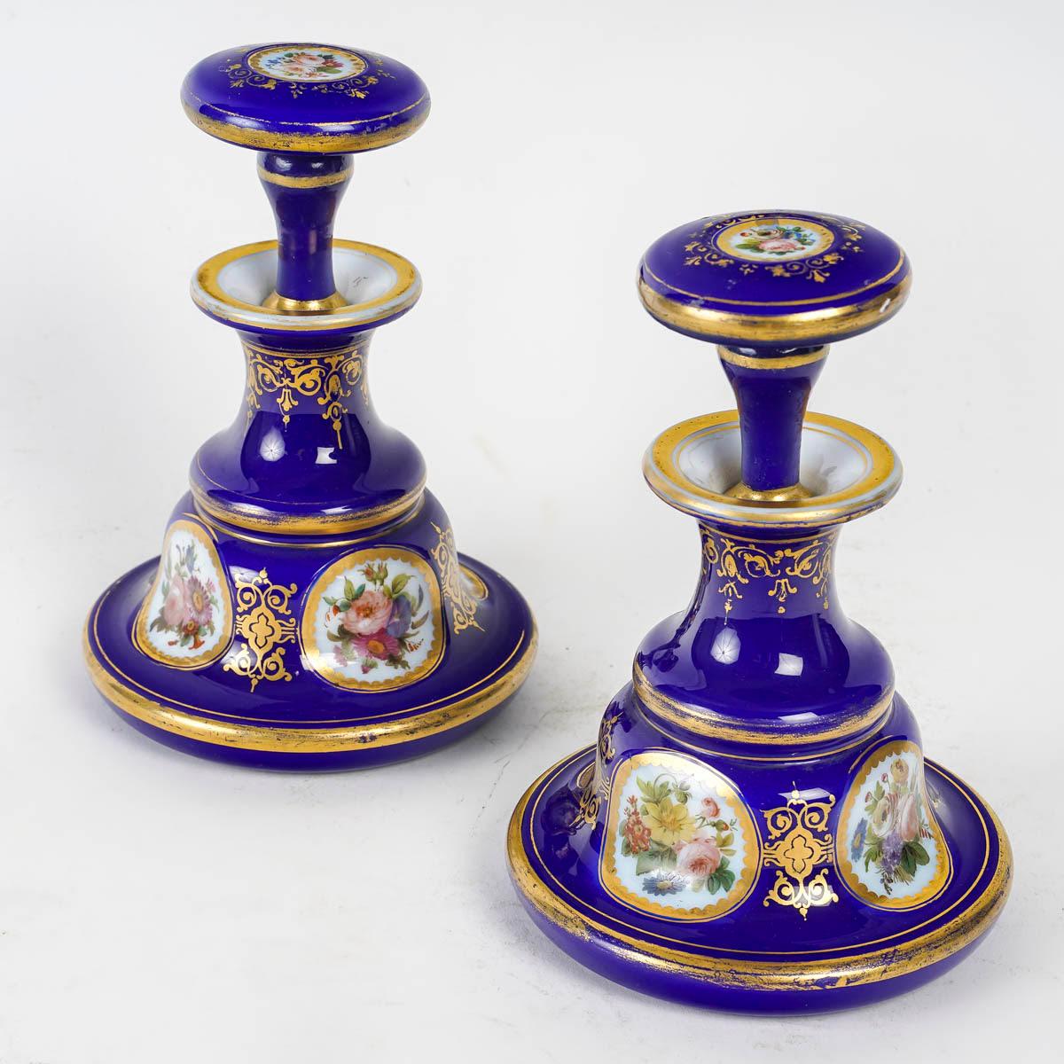 Pair of Blue Opaline Overlay bottles, 19th century, Napoleon III period.

A pair of blue opaline overlay bottles with gold highlights and floral decorations, 19th century, Napoleon III period.
h: 17cm, d: 12cm