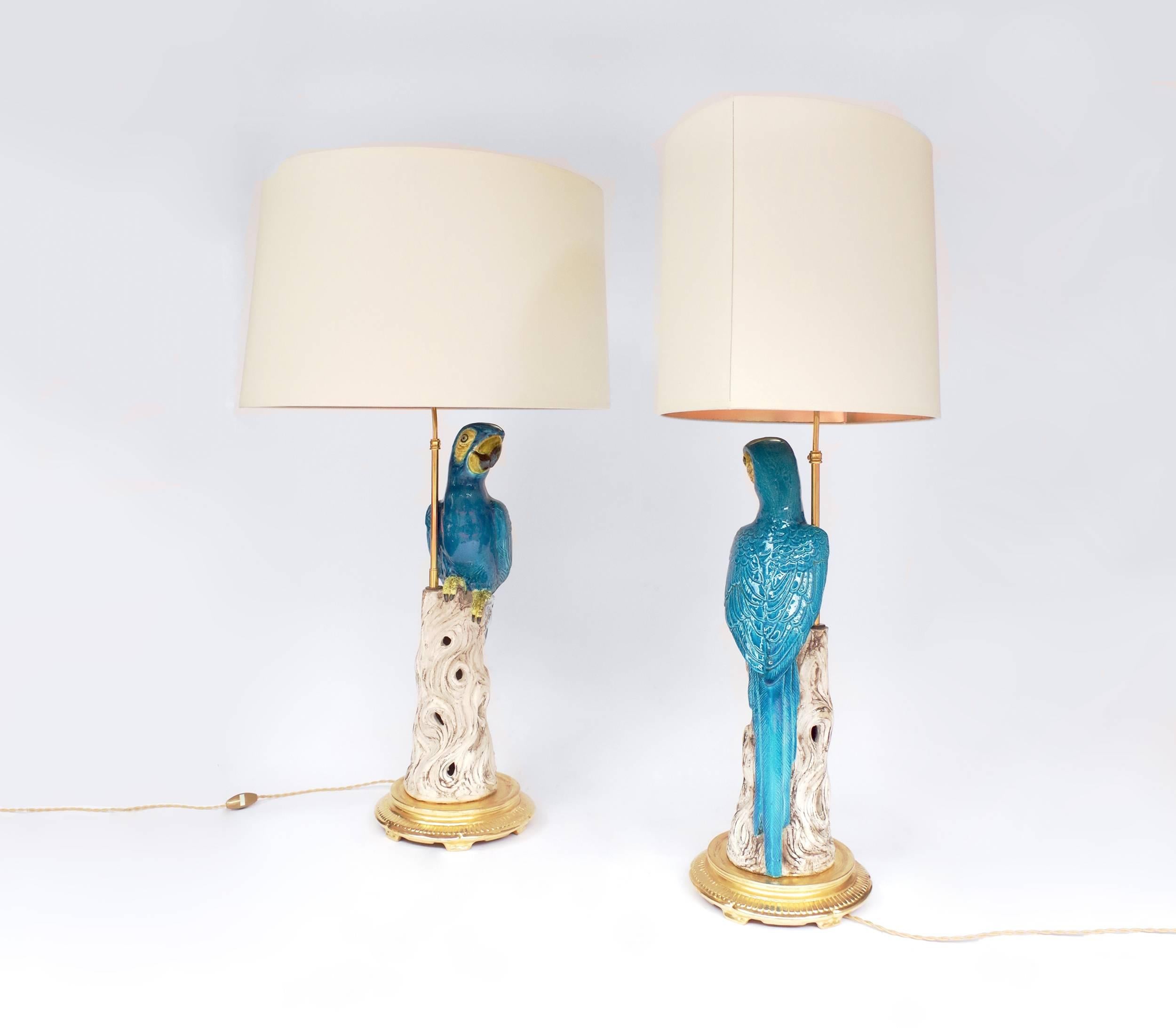 Paire of faience lamps representing blue parrots standing on a tree stump. The base is in gilt terracotta, looking like a gilt bronze mount.
Work of the 1970s, old electric system fully replaced by a functional new one (European type).

! The price