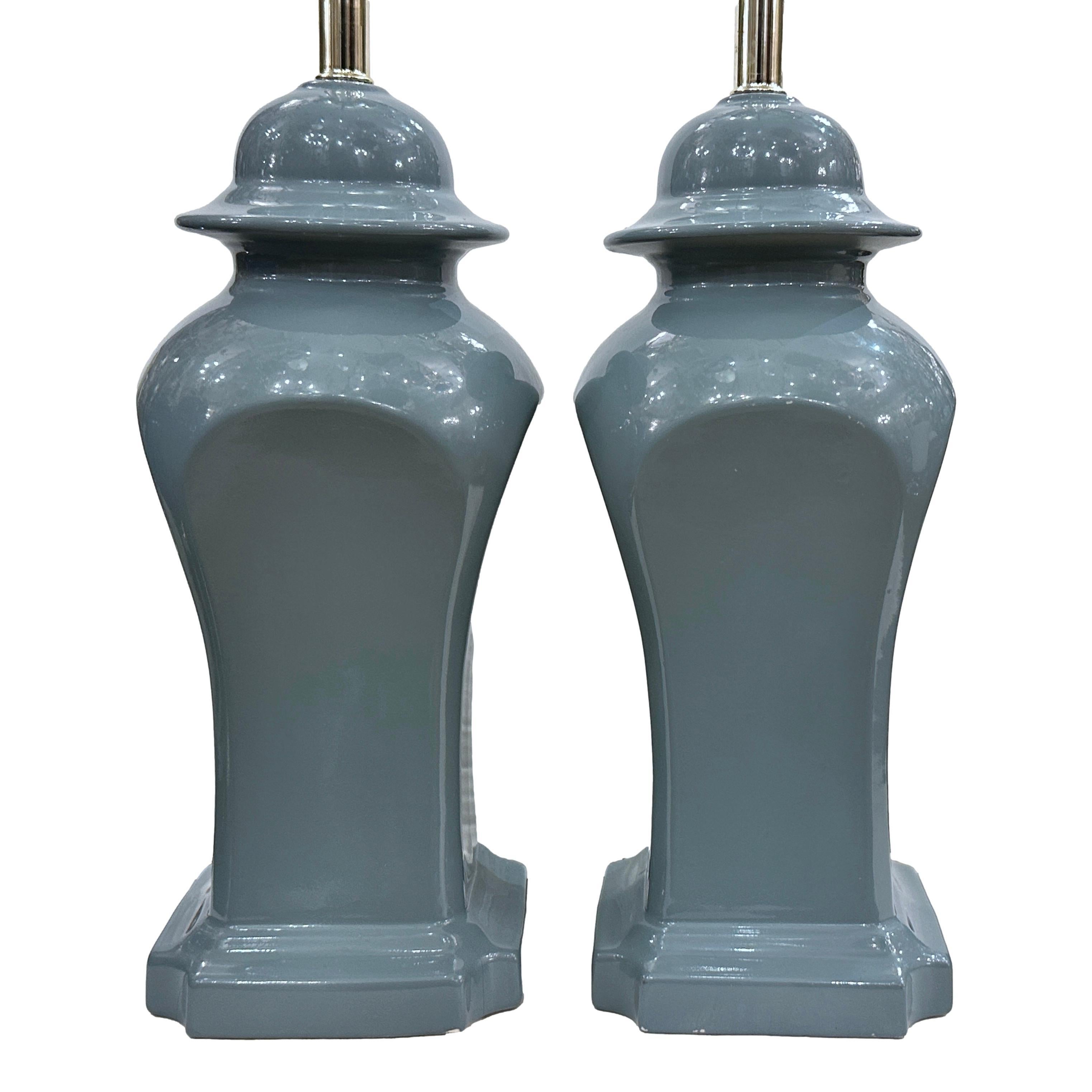 Pair of circa 1970's French porcelain table lamps with square urn shape.

Measurements:
Height of body: 17