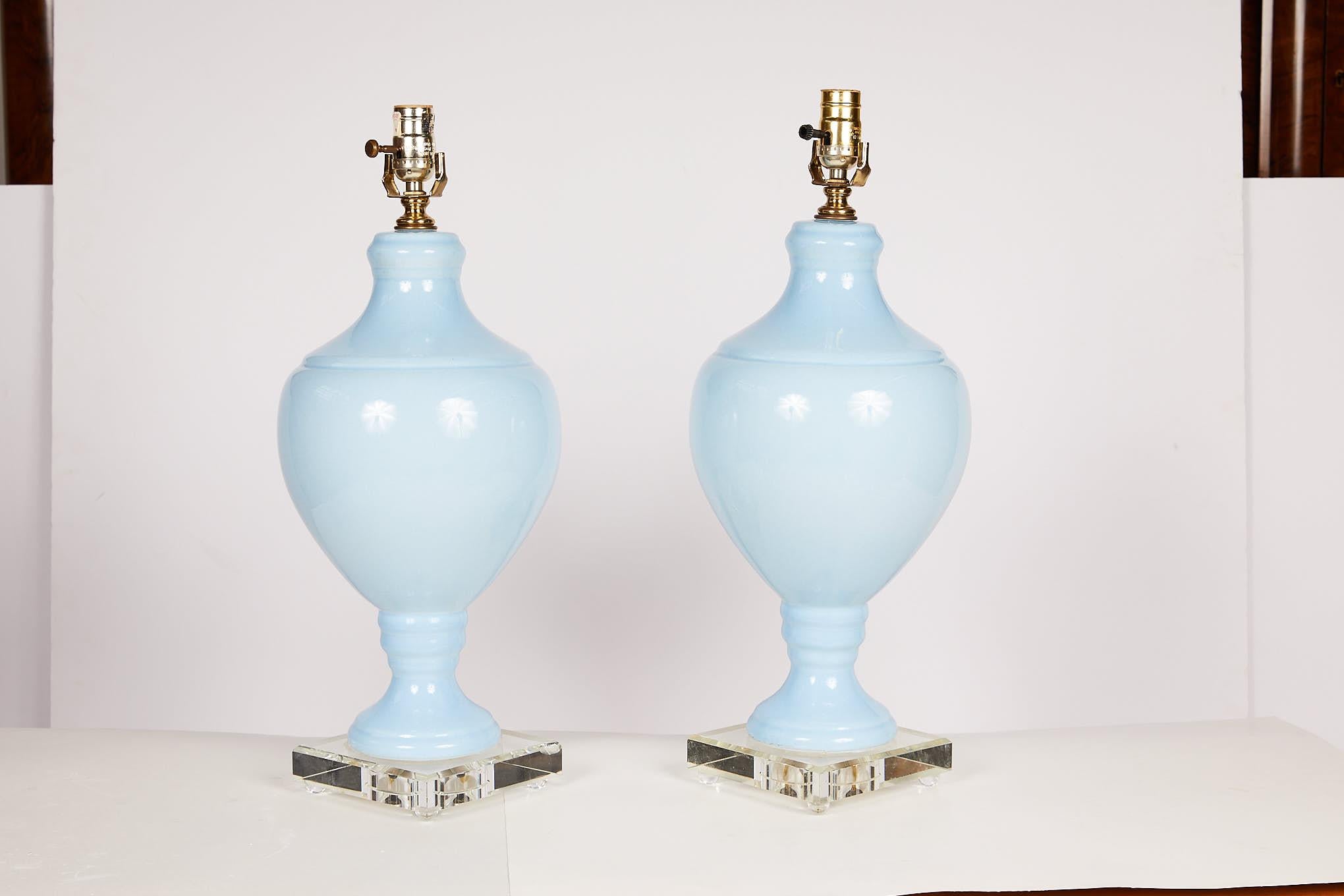20th century pair of pale blue urn shaped lamps mounted onto square Lucite bases.