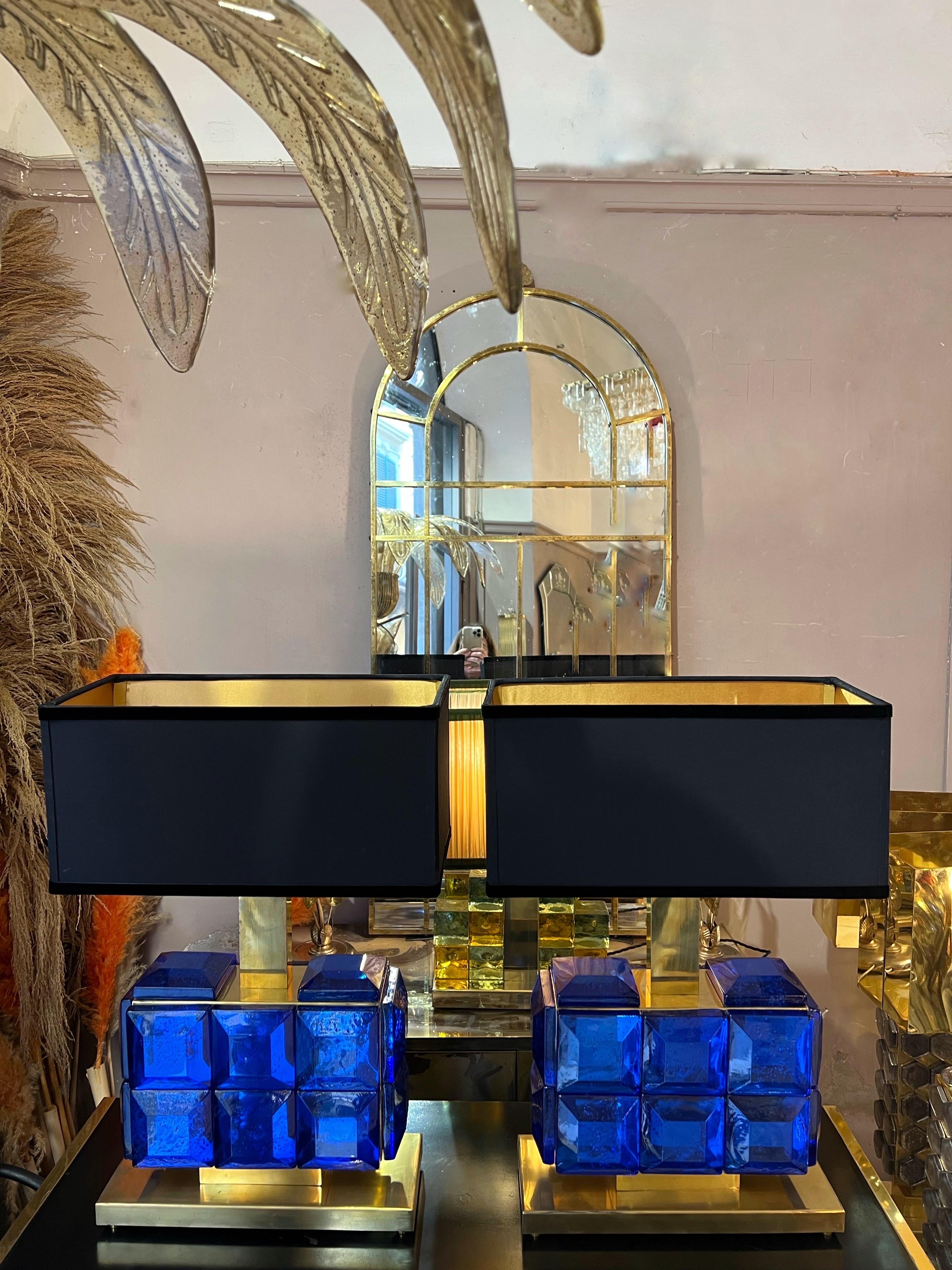 Pair of blue sapphire Murano glass Jewel table lamps with brass base. We have realized our handcrafted lampshades in black fabric outside and gold inside, black velvet edge.
Measures of the lamp without lampshade: cm 39 x 15 x H 30.