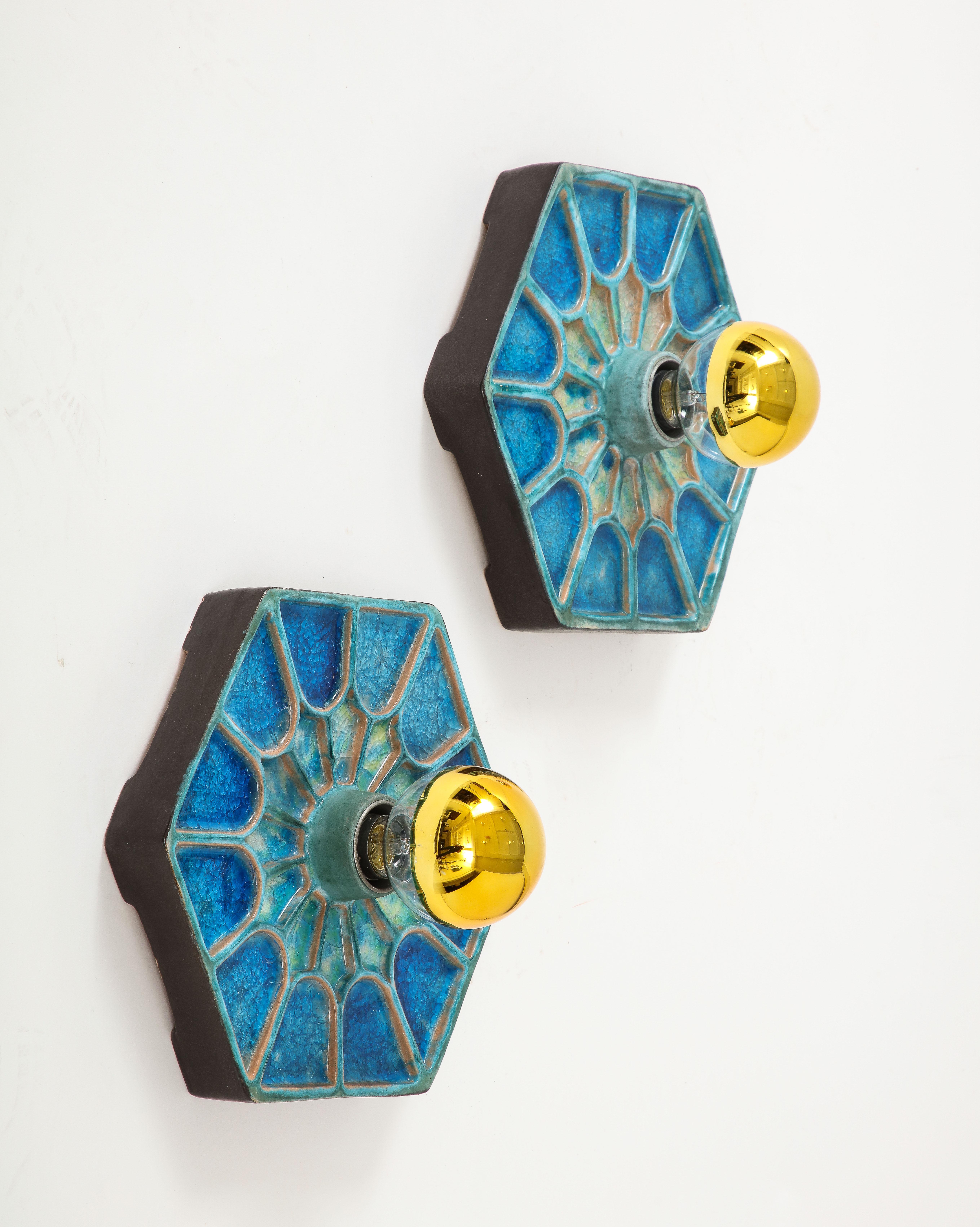 Unique pair of vibrant shades of blue ceramic wall lights. 
Hexagonal shape.
European sockets and wiring.