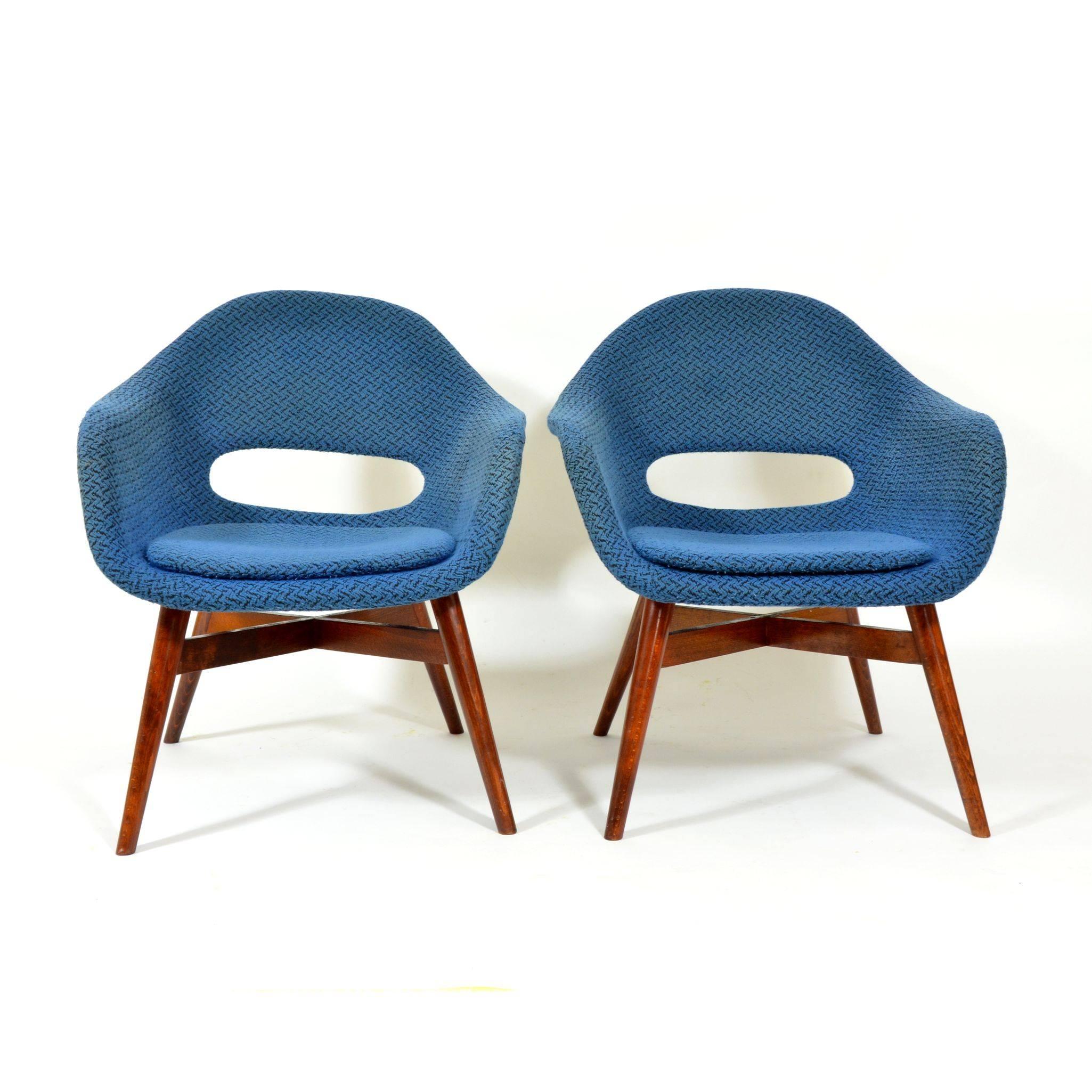 Very popular and design valued lounge chair by Miroslav Navrátil. Made of fiberglass shell, with original blue furniture fabric with visible structure. The wooden base made of stained beech is in original, very good, condition. Produced in former