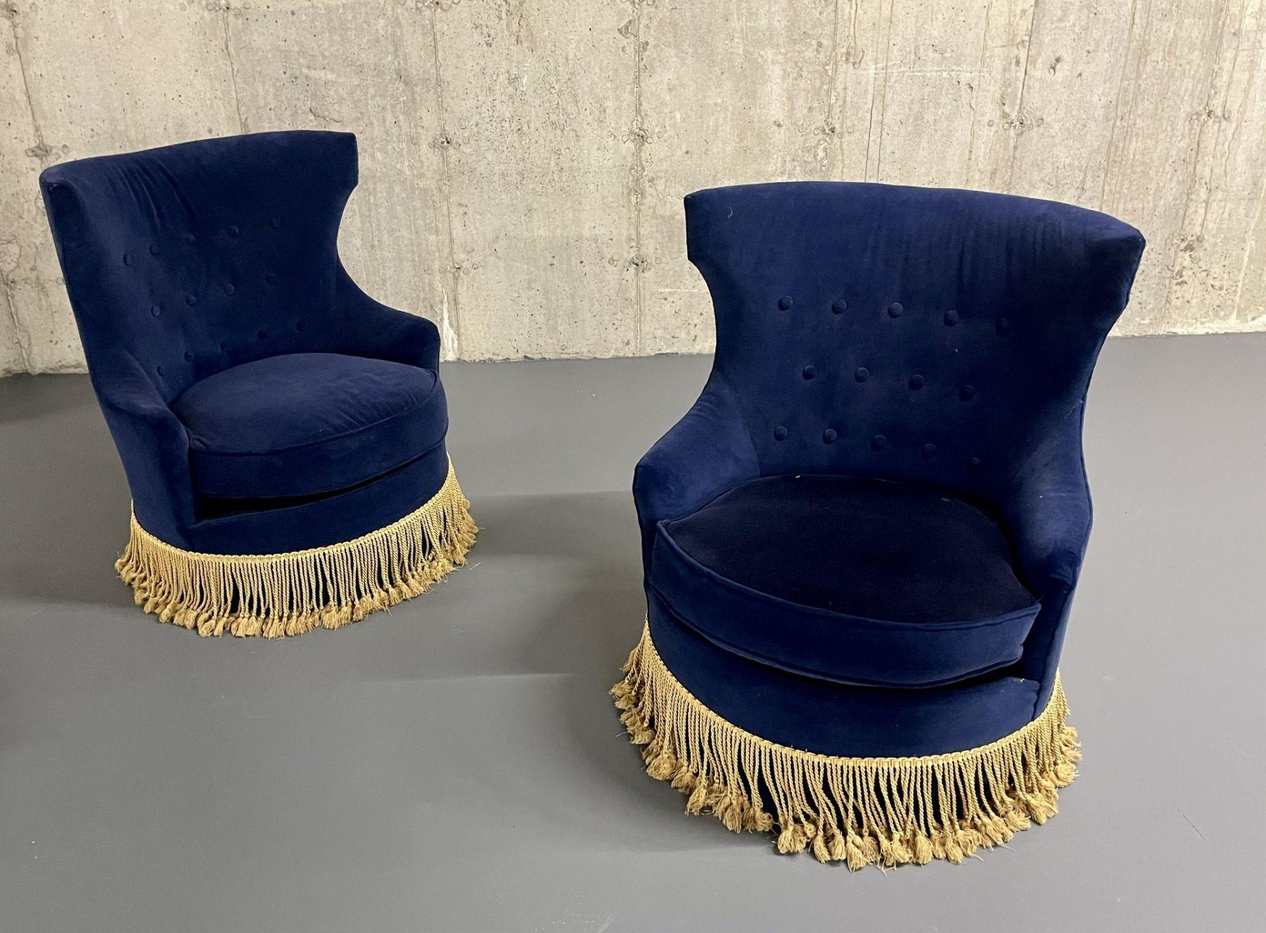 Pair of Mid-Century Modern blue tufted back slipper swivel chairs, velvet

Pair of transitional style chairs having a gold fringed trim and in the manner of Milo Baughman. 

Measures: 35.5 H x 28.5D x 30 W

Seat Height: 17.5
 
 IPZ.