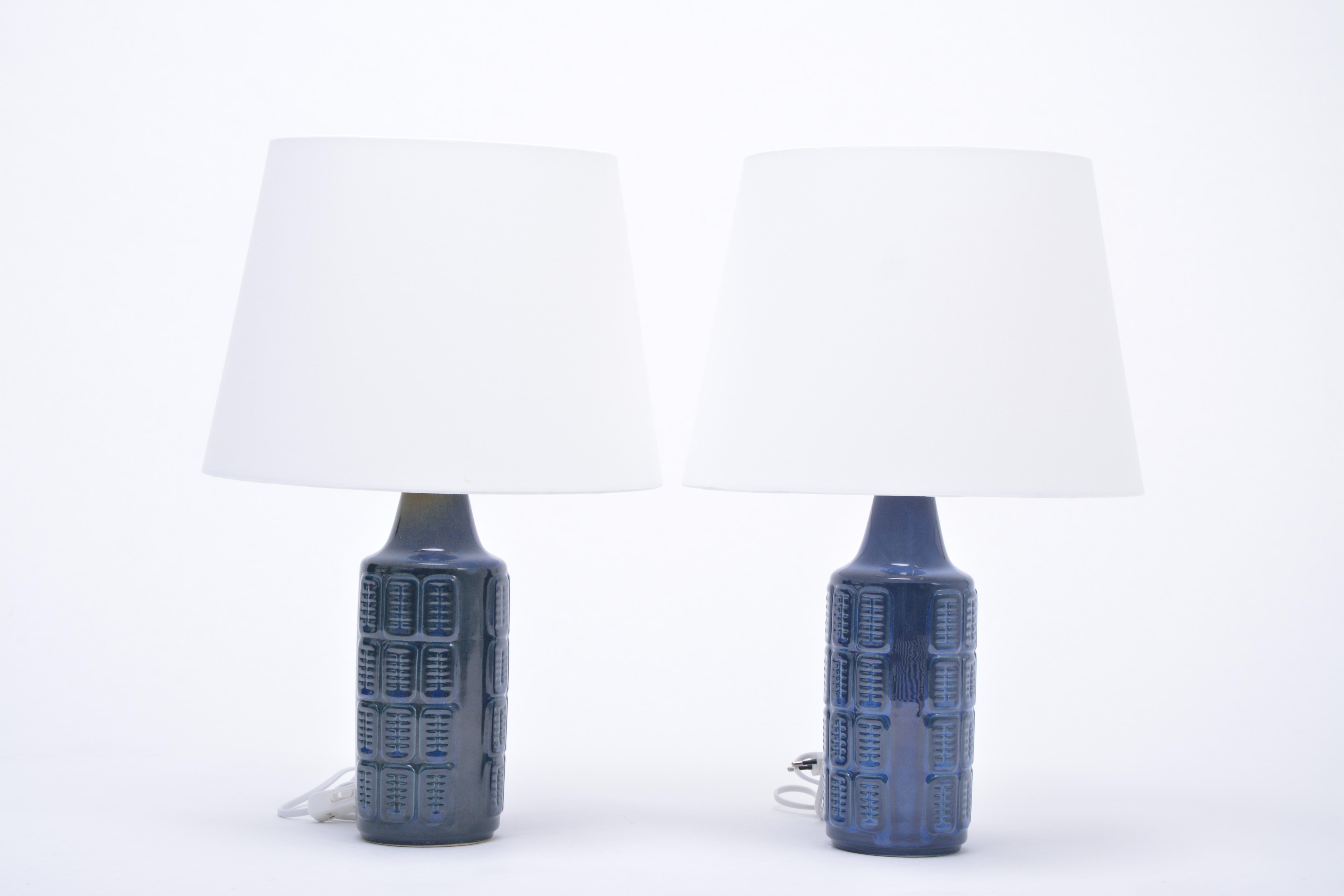 Pair of blue Mid-Century Modern stoneware lamps by Einar Johansen for Søholm

Pair of blue table lamps made of stoneware with ceramic glazing in dark blue. The bases feature a graphic pattern. Produced by Danish company Søholm. The lamps have been