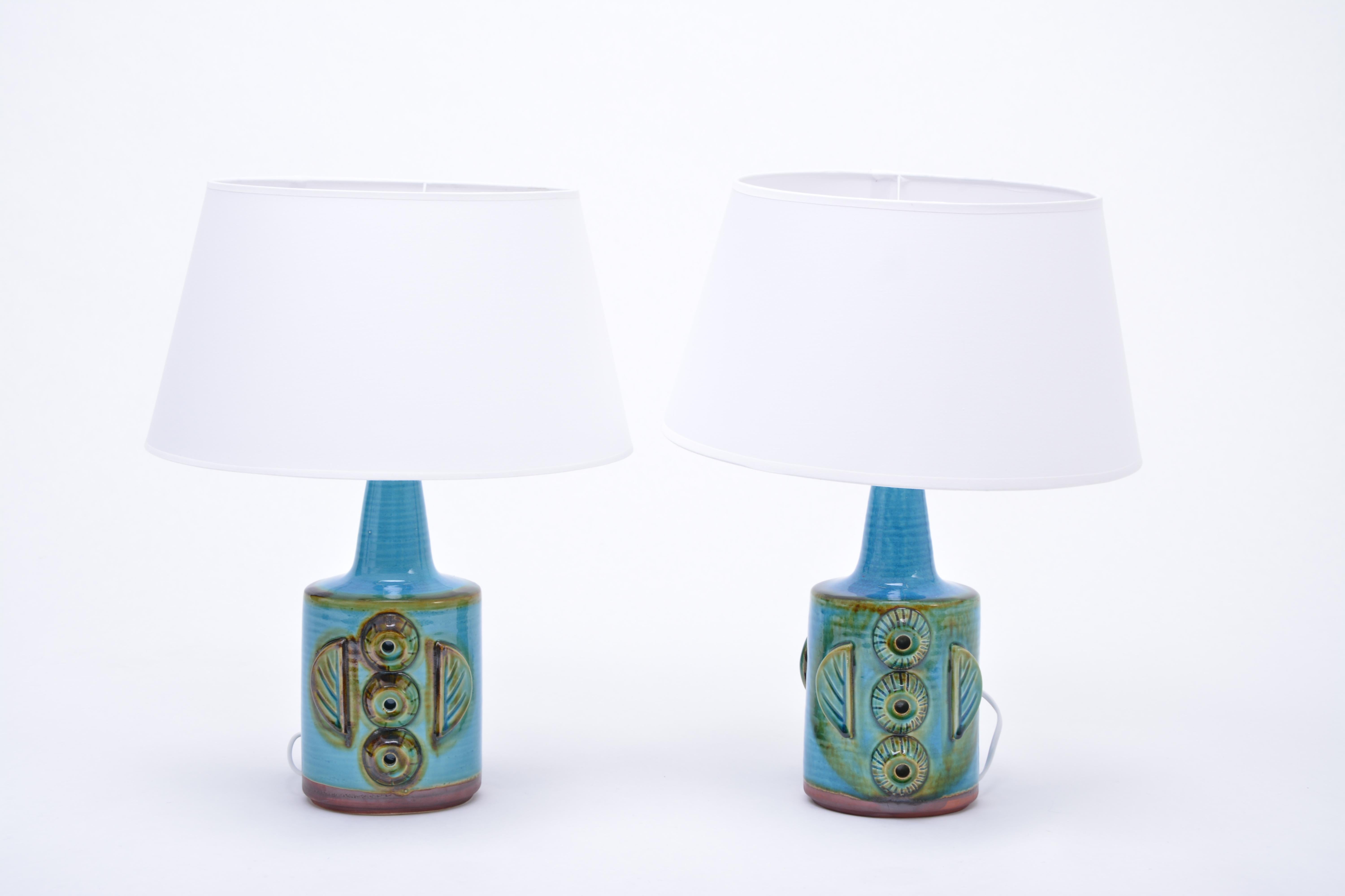 Pair of Blue Mid-Century Modern Stoneware table Lamps model 1203 by Søholm

Pair of blue table lamps made of stoneware with ceramic glazing in light blue. The bases feature ceramic applications. Produced by Danish company Søholm. The lamps have been