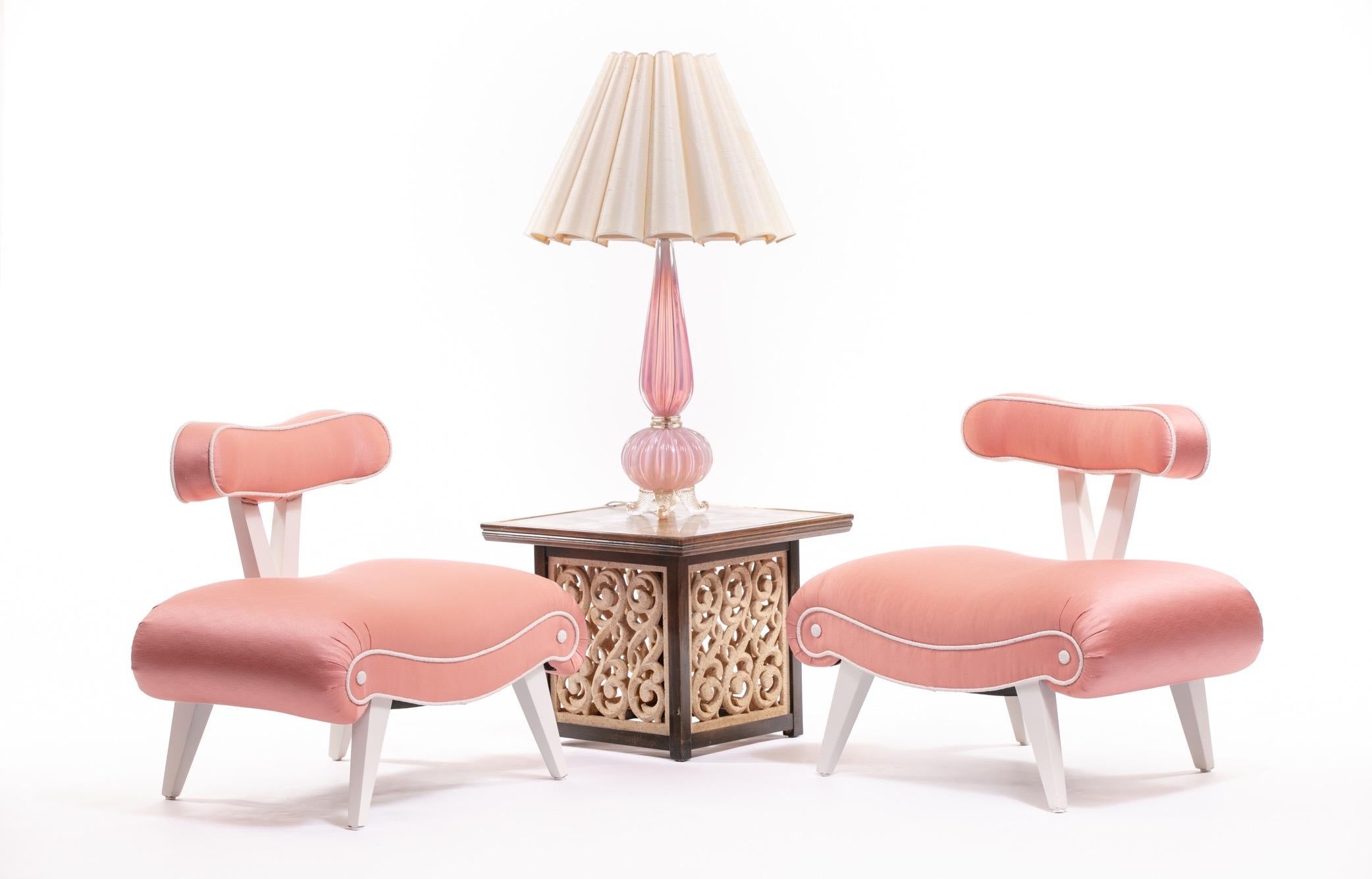 To die for, right? So Barbie. The curves... accentuated in Pink-Peach satin luster, highlighted by ivory bouclé piping detail and ivory bouclé tufts. Luxurious wide seats freshly and perfectly padded for comfort. And iconic. These Hollywood Regency