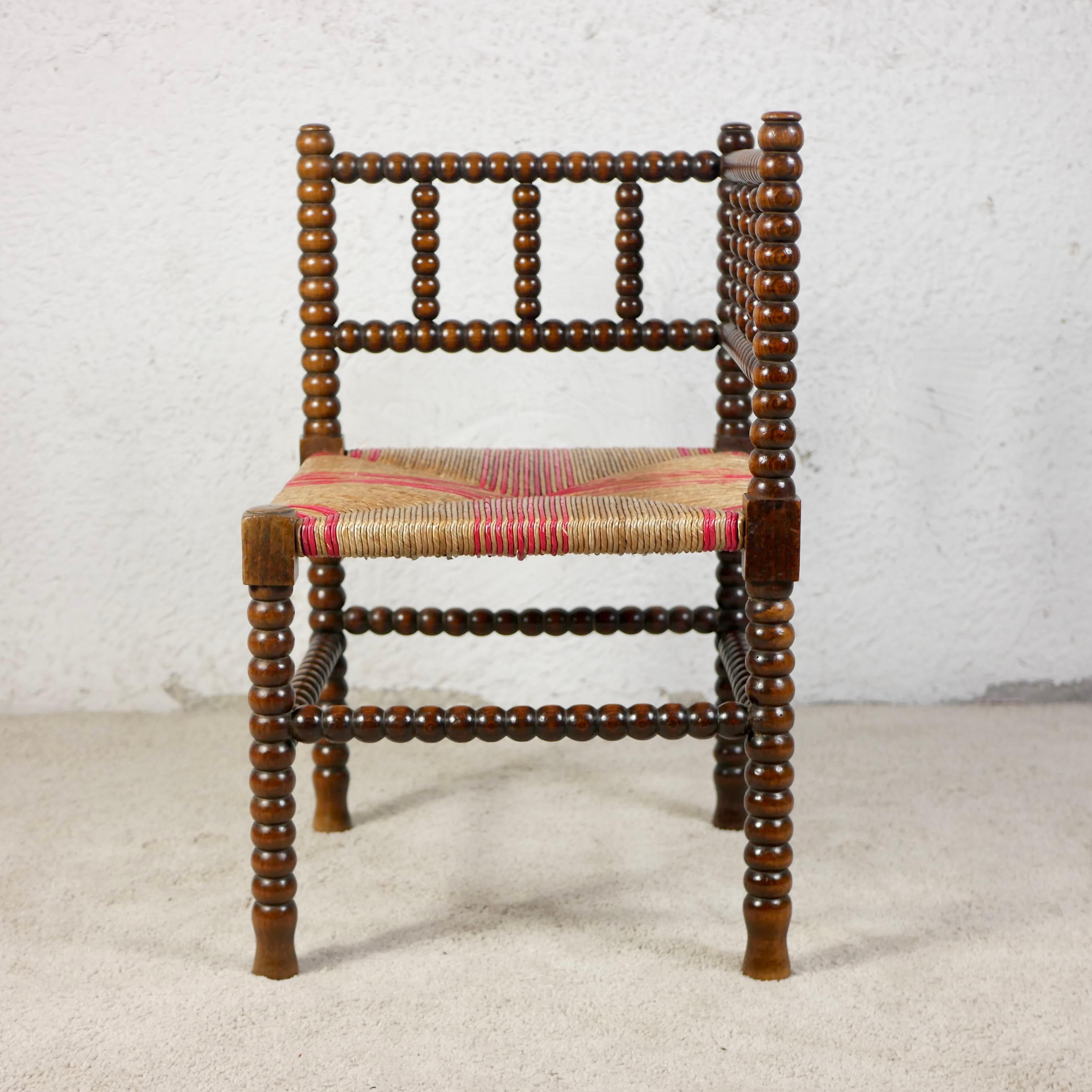 French Provincial Pair of Bobbin corner chairs, wood and straw, France, early 20th century For Sale