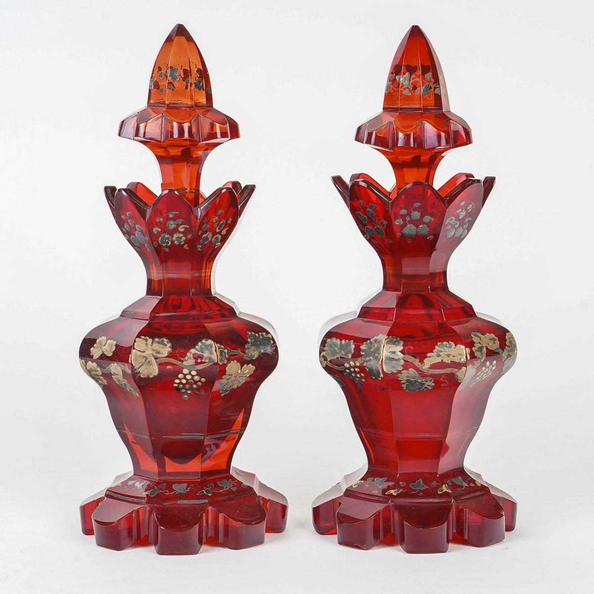 Pair of Bohemian Crystal Perfume Bottles, 19th Century, Napoleon III period.

Pair of Perfume Bottles, 19th century, Napoleon III period in red Bohemian crystal enamelled in silver.
h: 20cm, d: 8cm