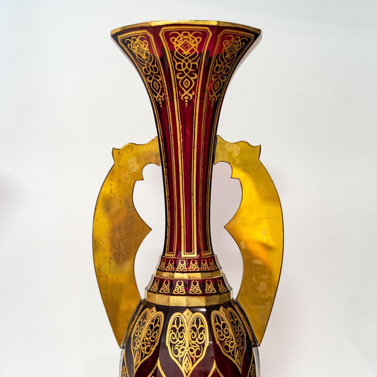Pair of Bohemian cut crystal vases in ruby red and gold, 19th century
A very important pair of Bohemian crystal vases in ruby red and gold, unique for their design and size, presented at the Alhambra Palace.
Measures: H: 70 cm, W: 23.5 cm, D: 23
