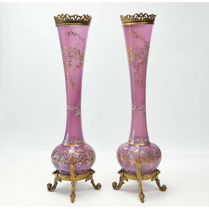 Pair of Bohemian enamel purple glass & gilt bronze mounted vases, 19th century.

Pair mid-century Bohemian glass & gilt bronze mounted vases. A four sided bulbous formed base with rich raided gilt & enamel decoration throughout. High quality