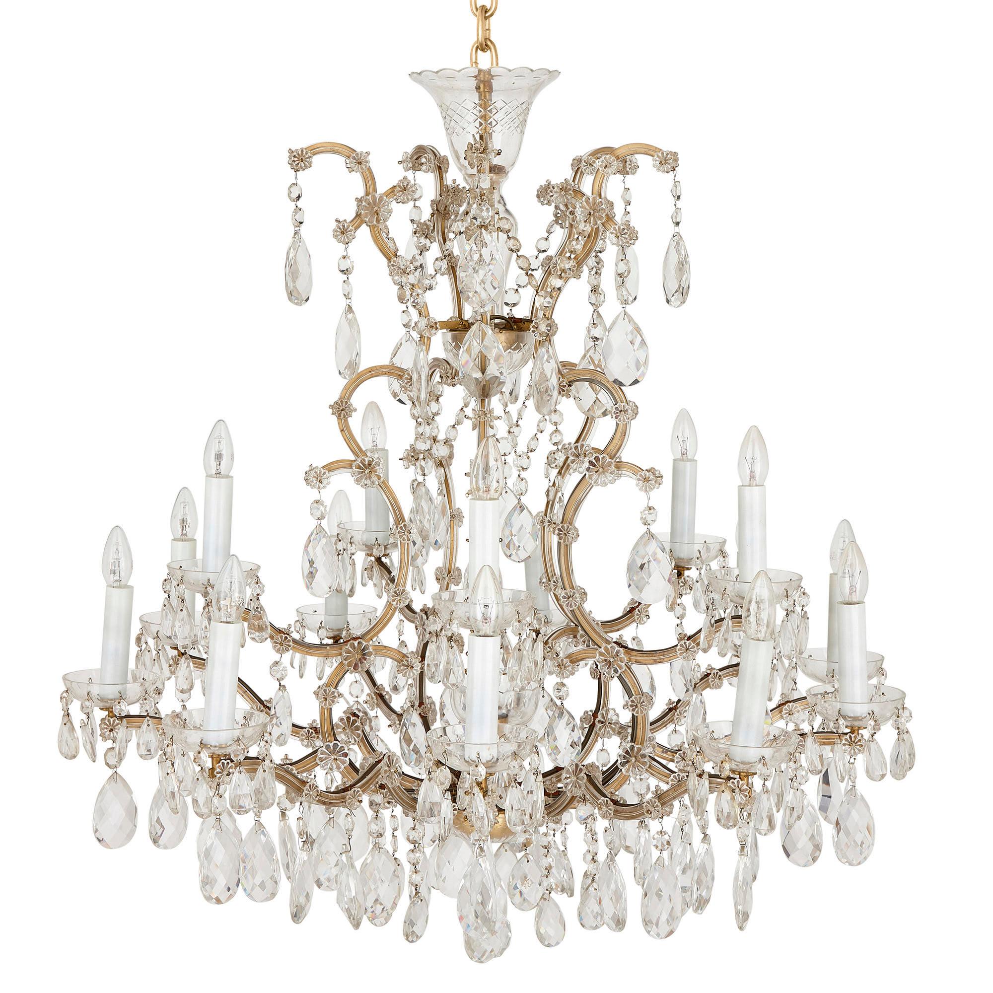 Pair of Bohemian faceted glass Rococo style chandeliers
Bohemian, 20th Century
Measures: Height 109cm, diameter 101cm

This pair of luxurious chandeliers is crafted in the Bohemian manner from wonderfully faceted cut glass. Each chandelier