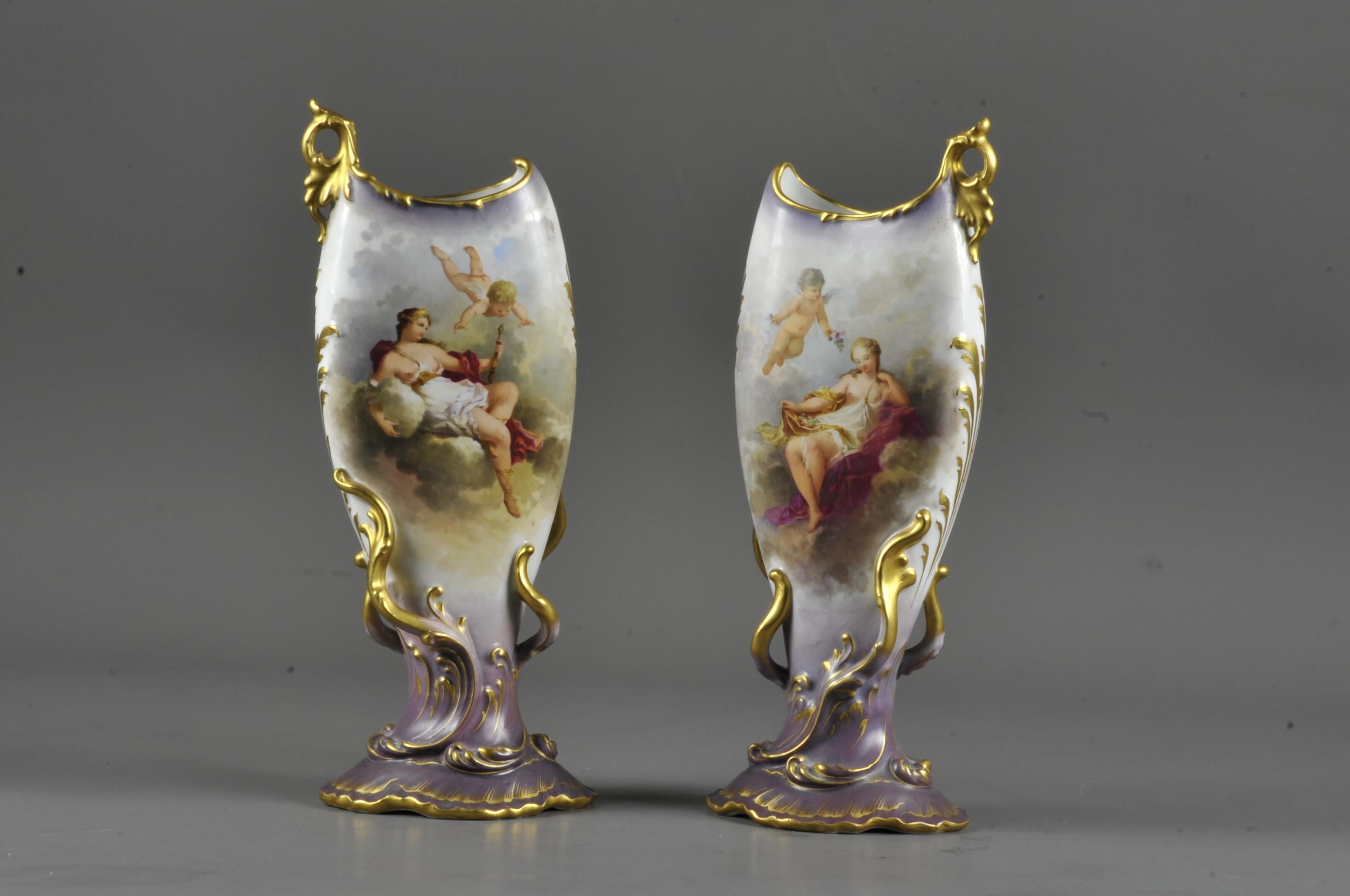 Magnificent and rare pair of vases from the Art Nouveau period and neo-romantic inspiration with turbulent shapes decorated with golden foliage, on a purple base and an elongated body in shades of gray.

The two slightly inclined vases accentuate