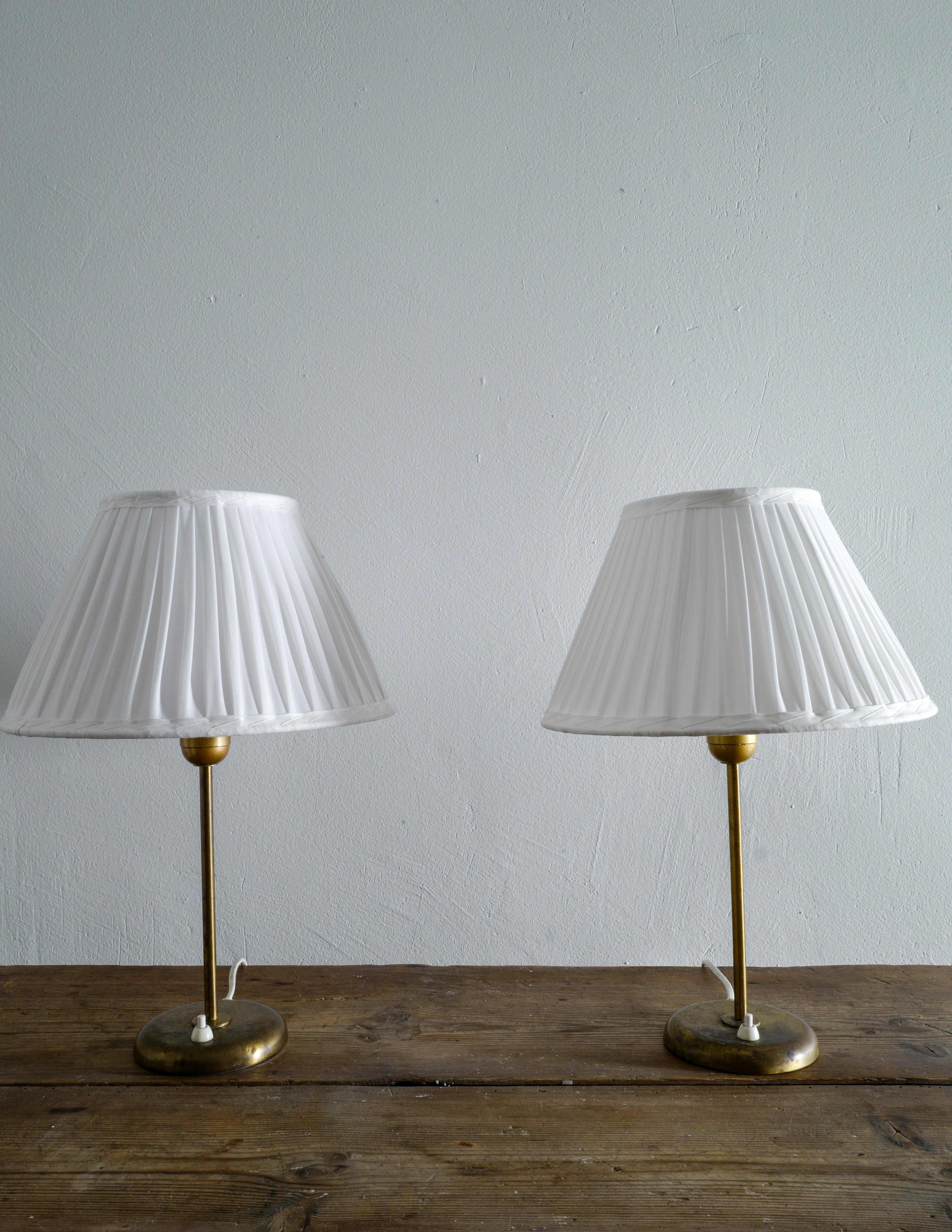 Rare pair of table lamps in brass produced by Böhlmark, Sweden in the 1950s. Lamps are in good vintage condition and showing beautiful patina from age and use. Shades are included in the purchase.