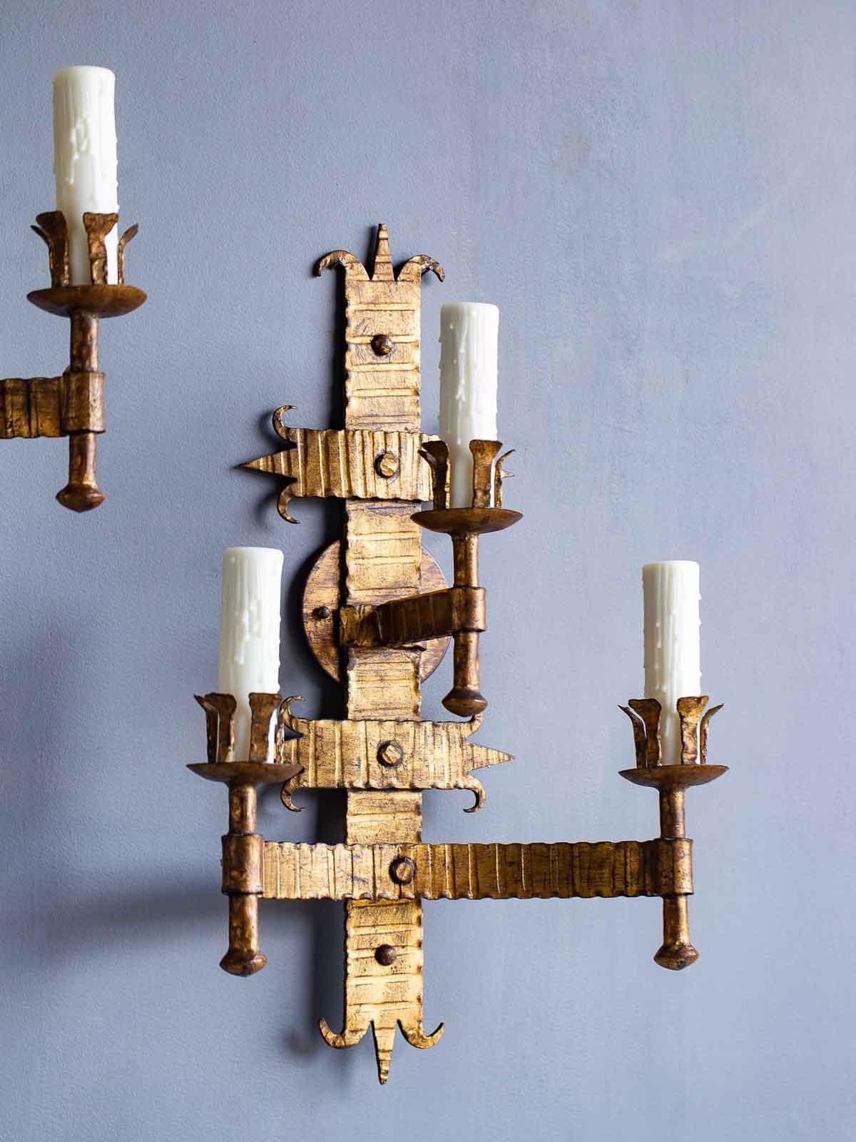 French Provincial Pair of Bold Scale French Three-Arm Gilded Iron Two Tier Sconces, circa 1920