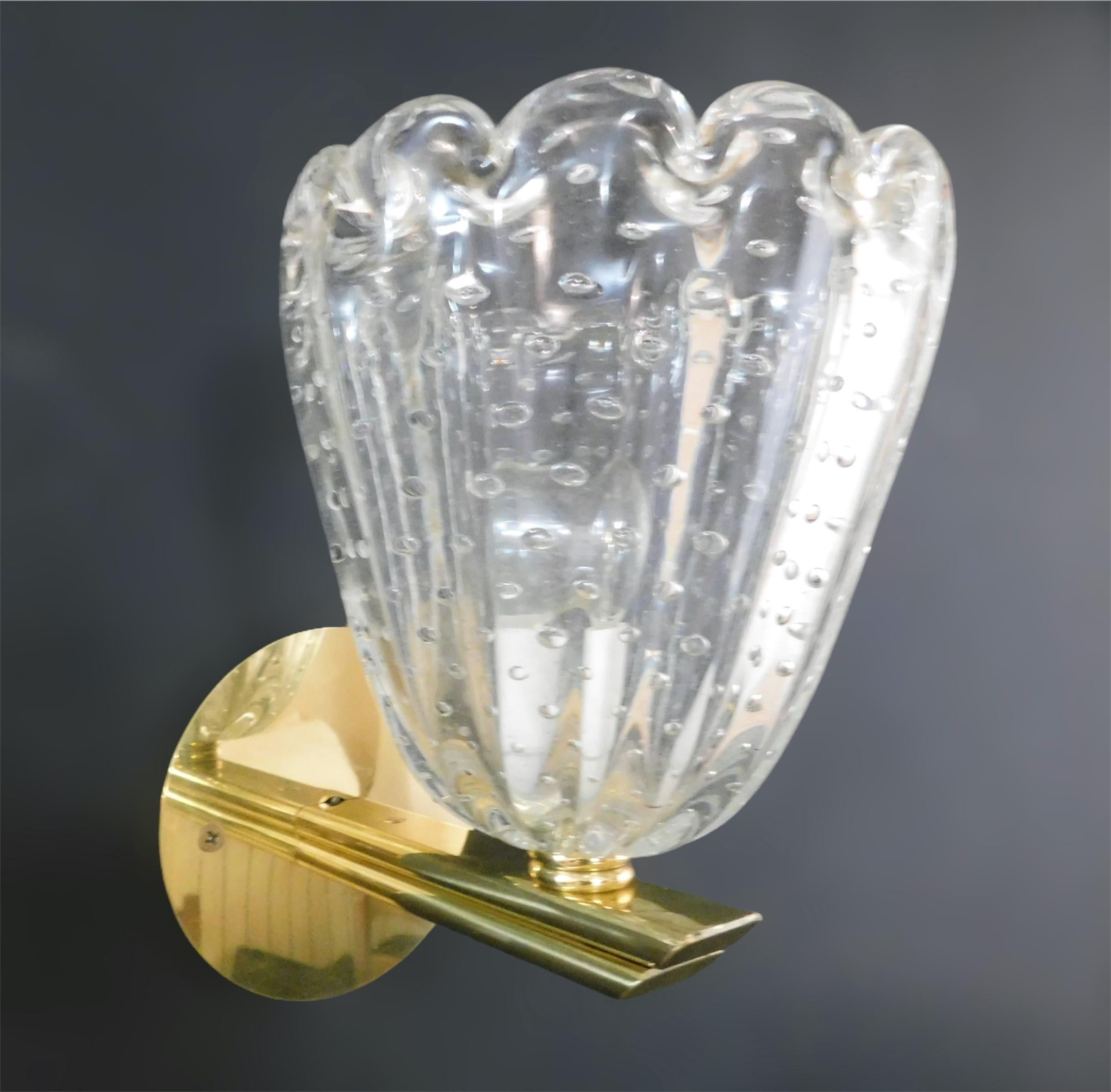 Vintage Italian wall lights with clear Murano glass cups hand blown with bubbles inside the glass using Bollicine technique, mounted on brass frames / Made in Italy, circa 1950s
Measures: Height 8 inches, width 7 inches, depth 8.5 inches
1 light /