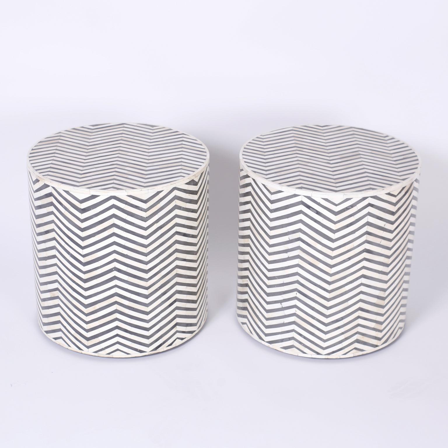 Pair of tables crafted with bone and dyed bone in a chevron or herringbone mosaic design over a Classic drum form.
  